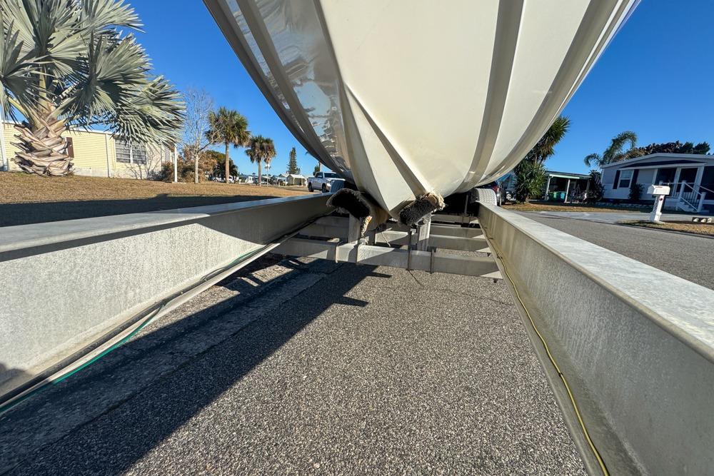 1989 Formula 292 SR-1 boat on trailer, viewed from below, with palm trees in background.
