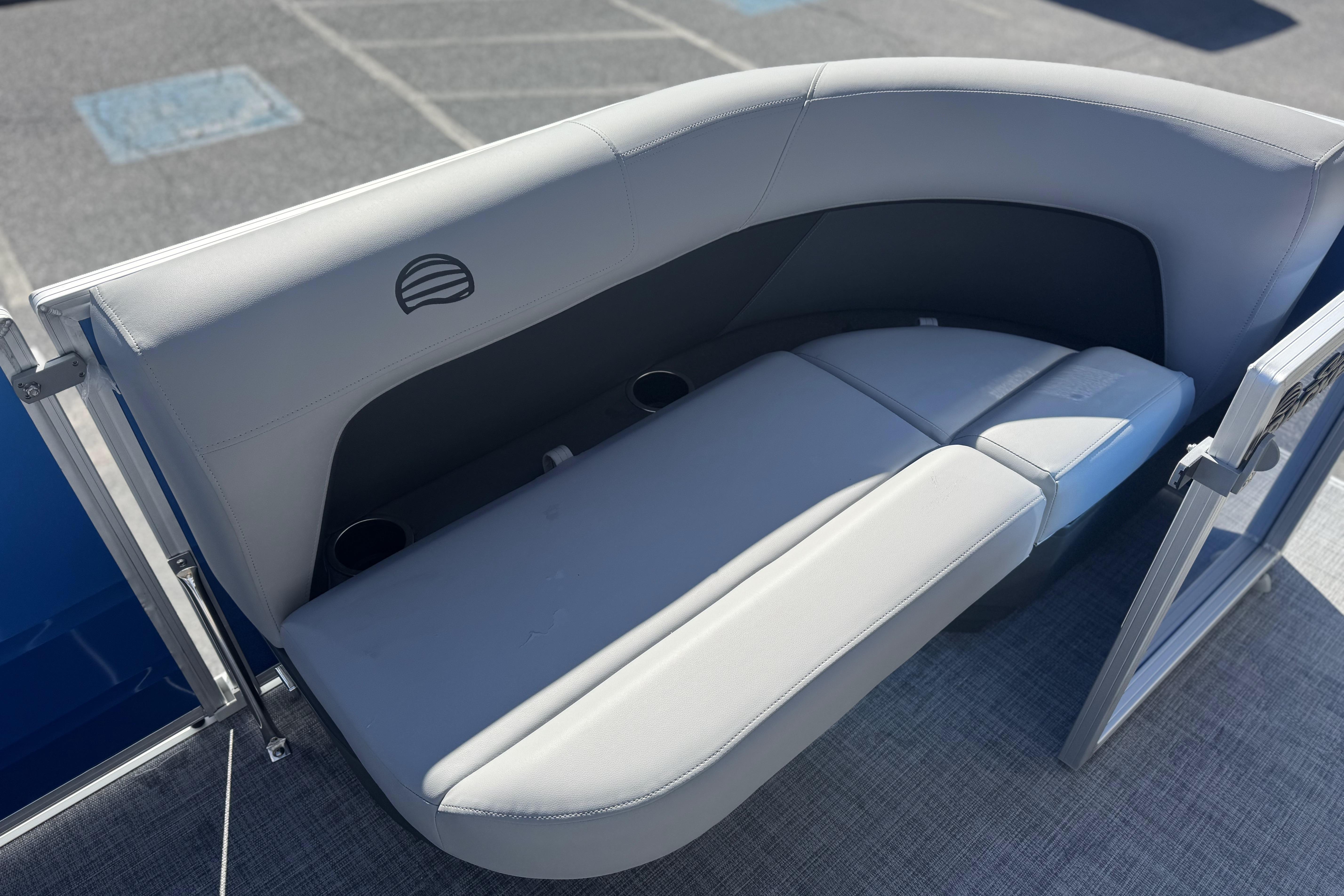 2026 Sun Tracker Party Barge 16 DLX pontoon boat seating area with cup holders.