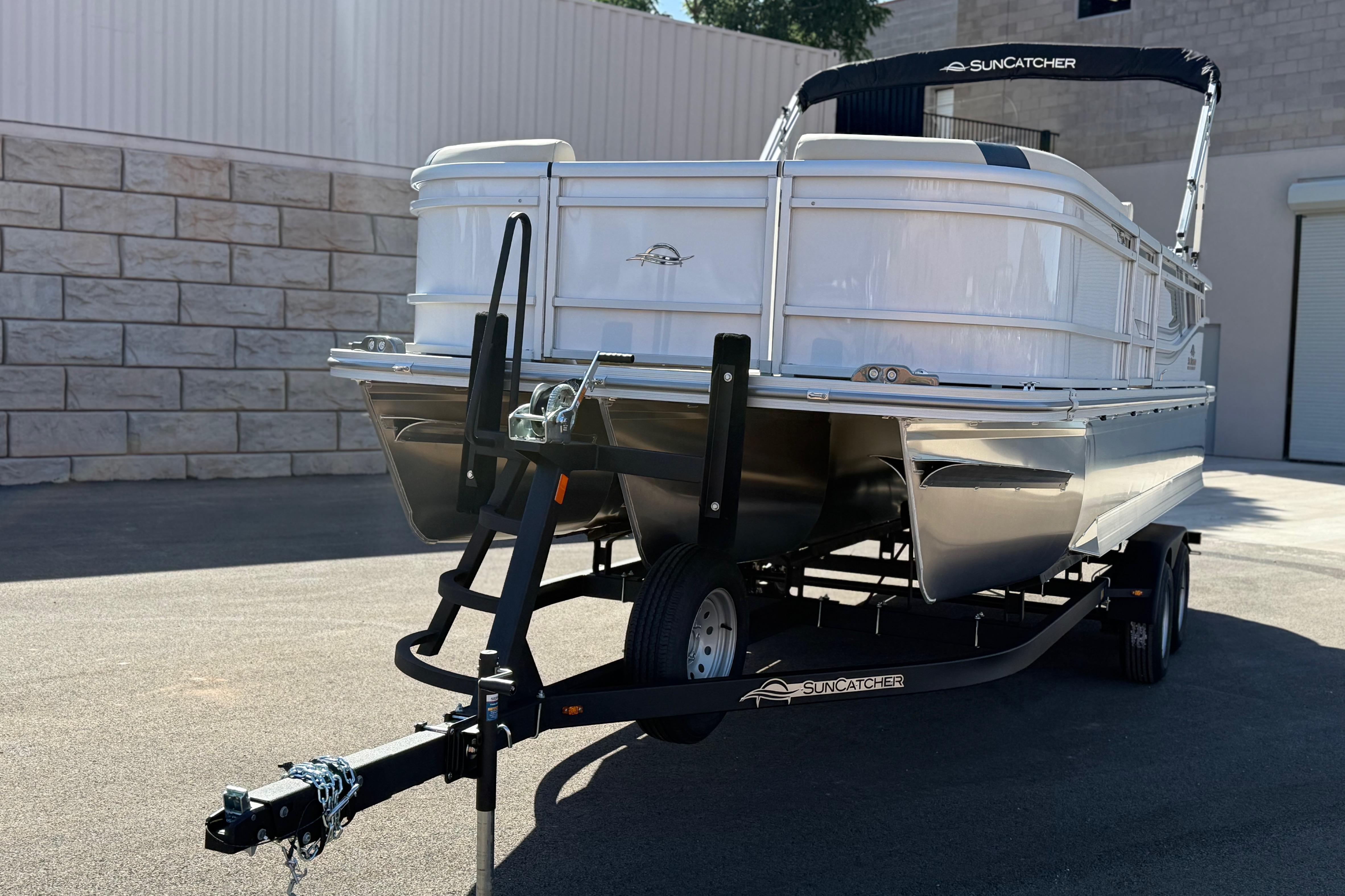 2026 SunCatcher Select 322SL pontoon boat on trailer, parked outdoors.