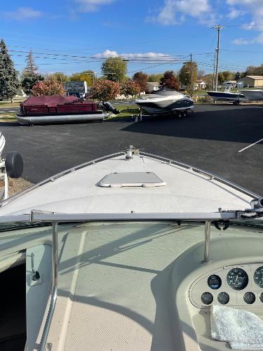 1992 Regal Ventura boat with dashboard view, parked outdoors under a clear blue sky.