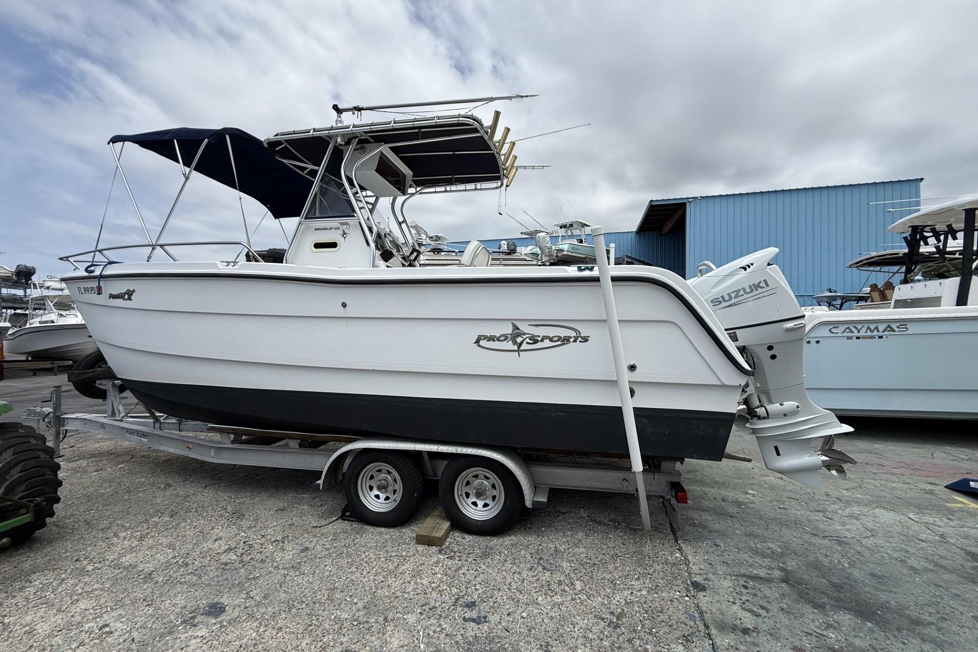 2002 Pro Sports 2200 CC ProKat boat on trailer with Suzuki outboard motor.