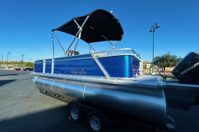 2026 Sun Tracker Party Barge 22 RF XP3 pontoon boat with blue exterior and black canopy.