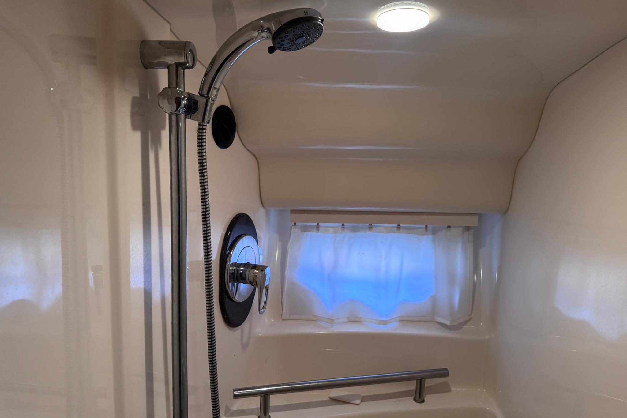 Shower area in 2004 Sea Ray 390 Sundancer yacht, featuring modern fixtures and window.