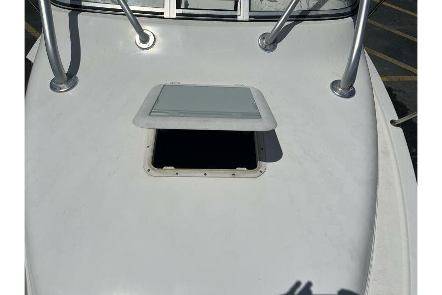 2006 Century 2400 Walk-Around boat deck with open hatch and metal railings.