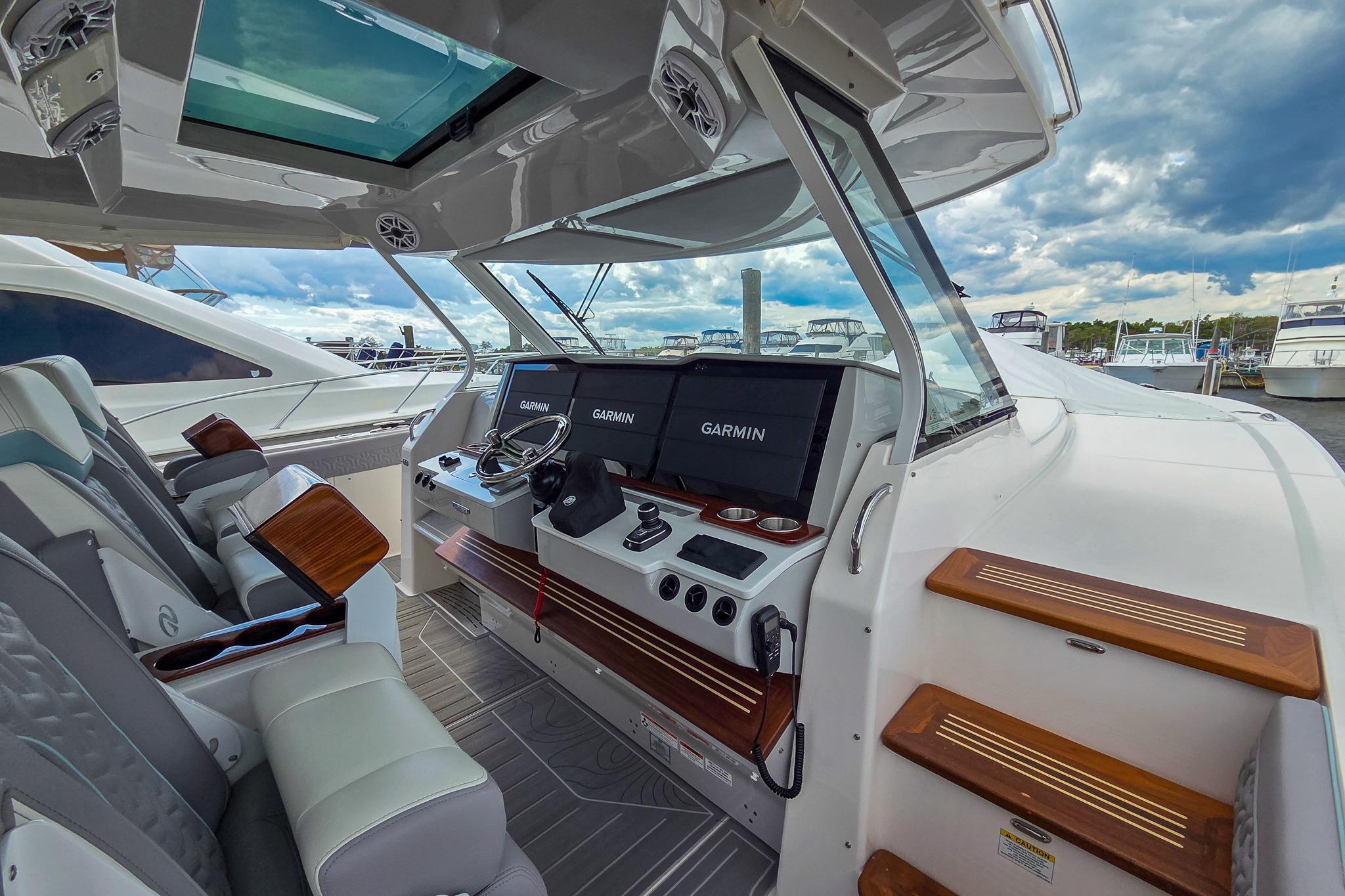 2025 Regal 50 SAV yacht cockpit with Garmin navigation, luxurious seating, and modern design.