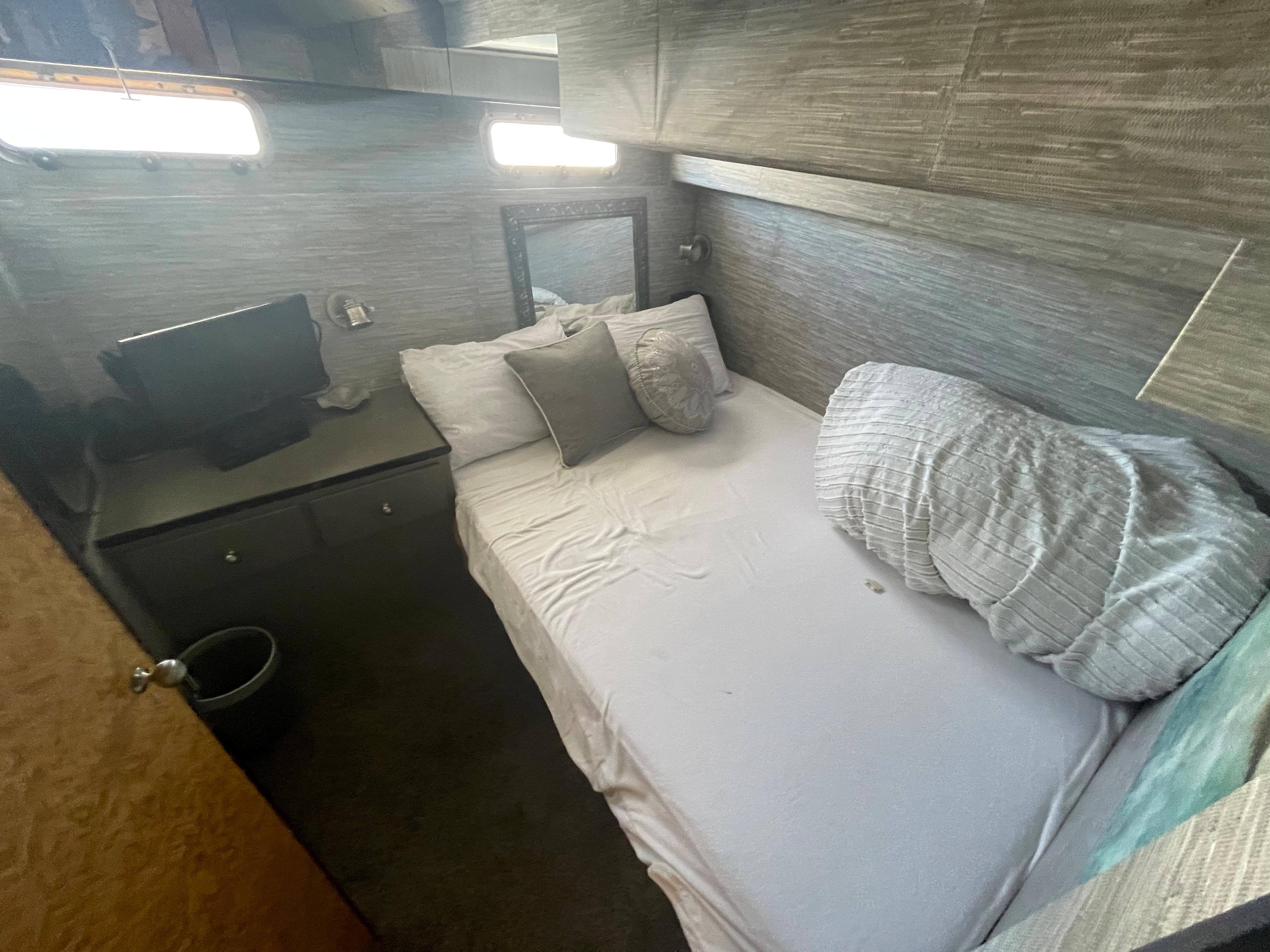 Cozy cabin interior of 1986 Sea Hawk Sedan with bed and small desk.