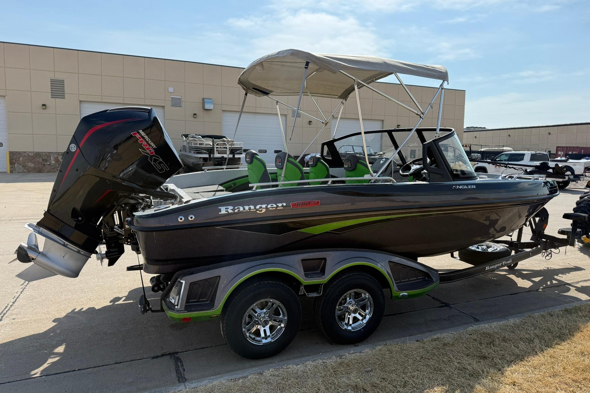 2026 Ranger 1880MS boat with canopy and trailer, parked outdoors.
