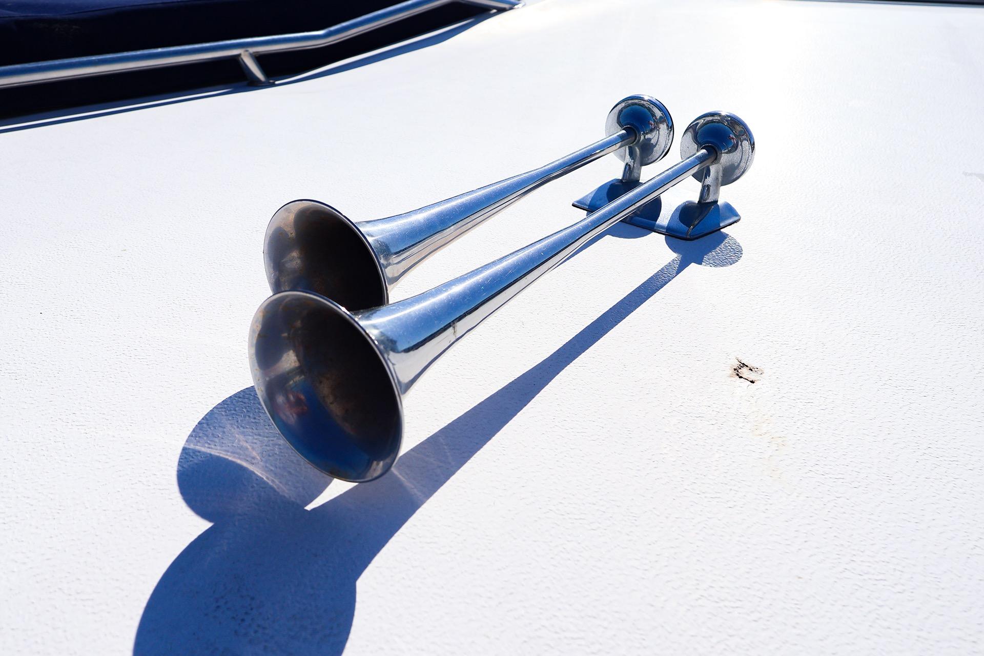 Chrome boat horns on 1998 Sea Ray 500 Sundancer deck, shining in sunlight.