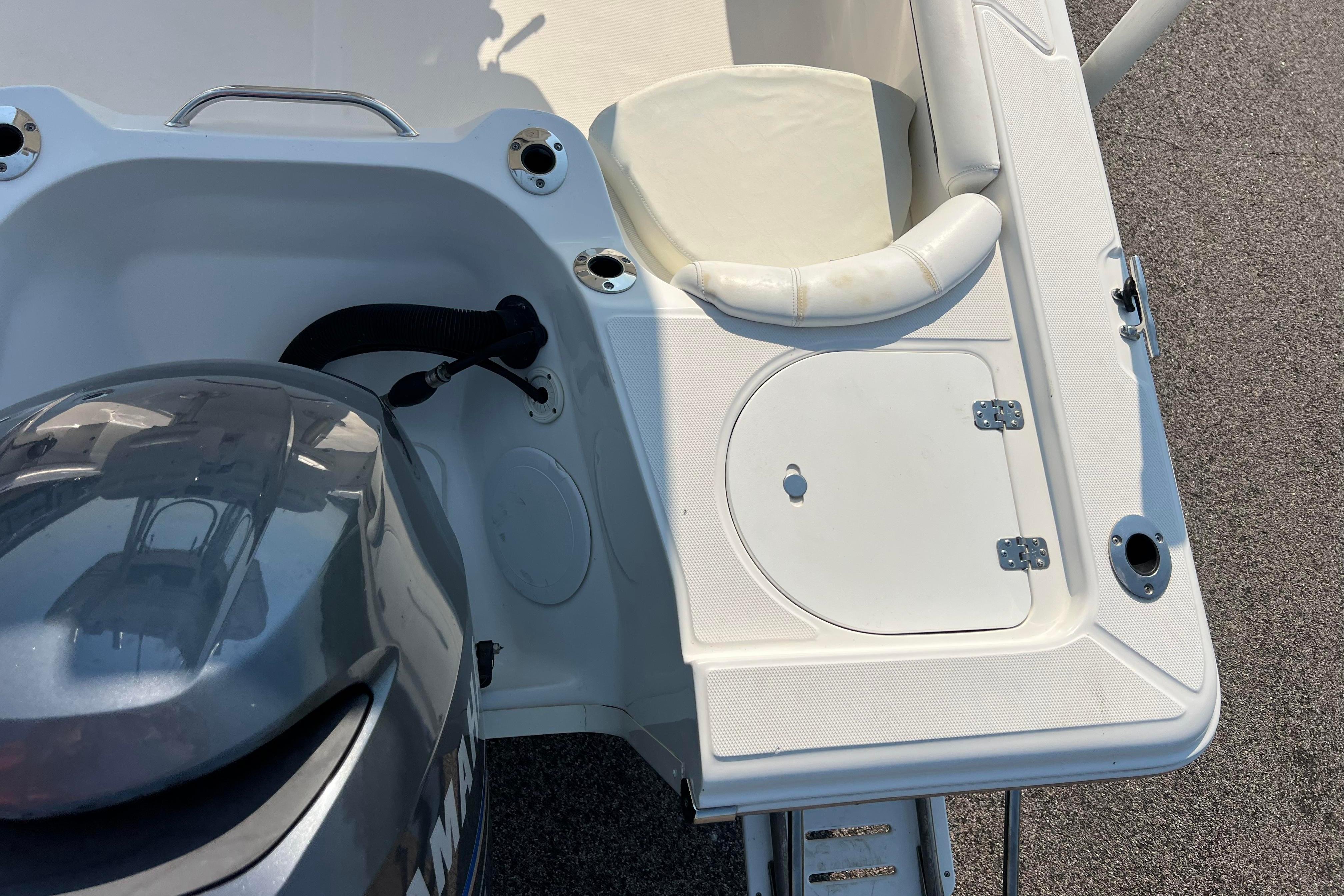 2012 Sea Fox 206 Center Console boat stern with engine and seating area.