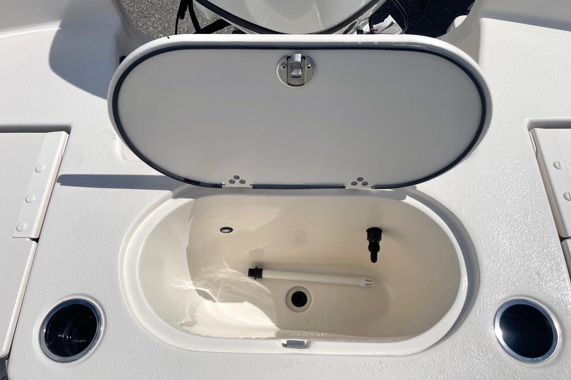 Open storage compartment on 2026 Carolina Skiff 19 LS boat deck.
