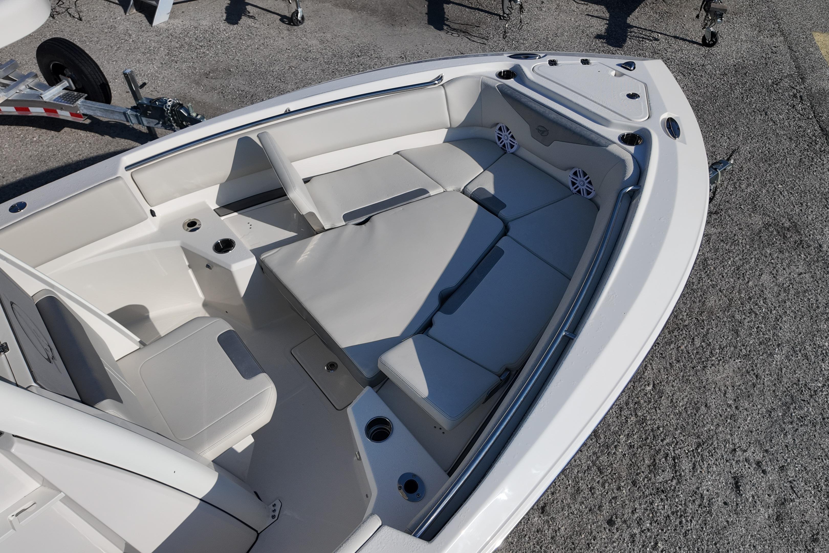 2026 Sailfish 232 CC boat interior with cushioned seating and cup holders.