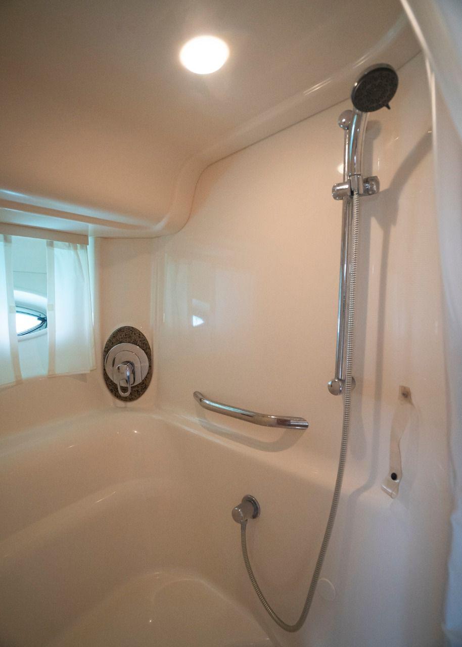 Shower area in 2006 Sea Ray 440 Sundancer yacht, featuring modern fixtures and lighting.