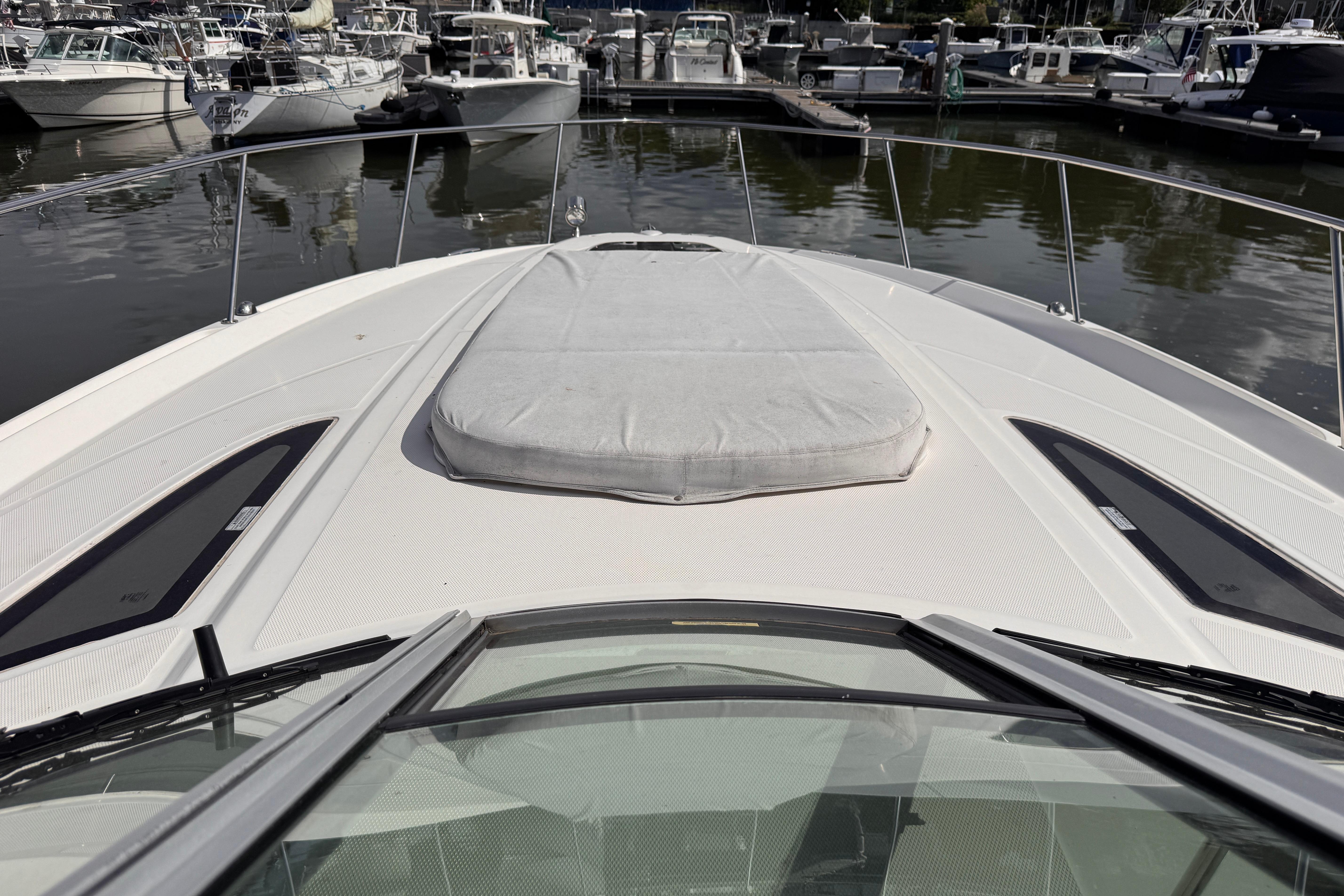 2008 Sea Ray Sundancer 350 yacht bow view at marina, showcasing sleek design and sunpad.
