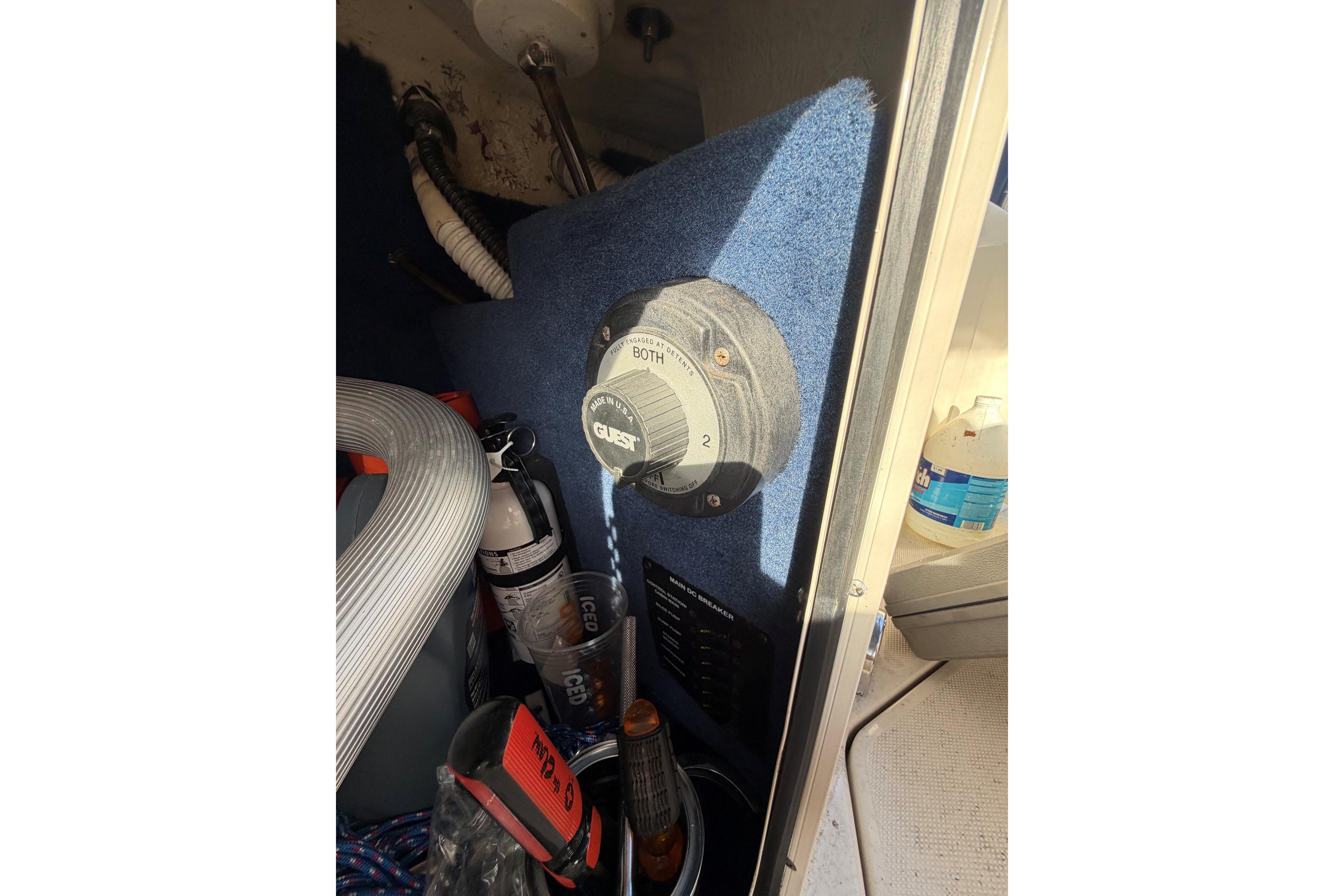 Battery switch and storage area inside a 2000 Sea Ray 240 Sundancer boat.