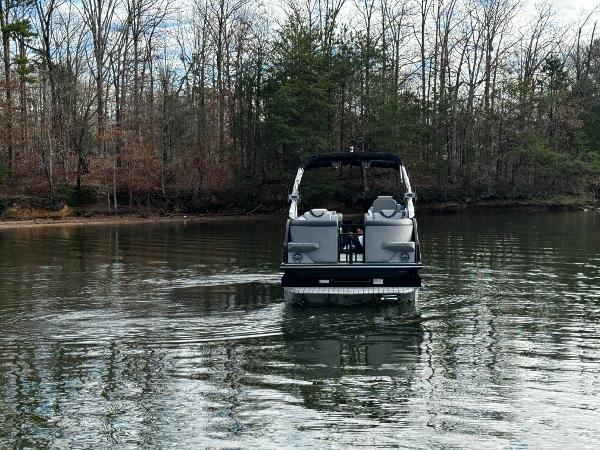 2025 Montara Surf Boss 2.0 25 on a serene lake with forest backdrop.