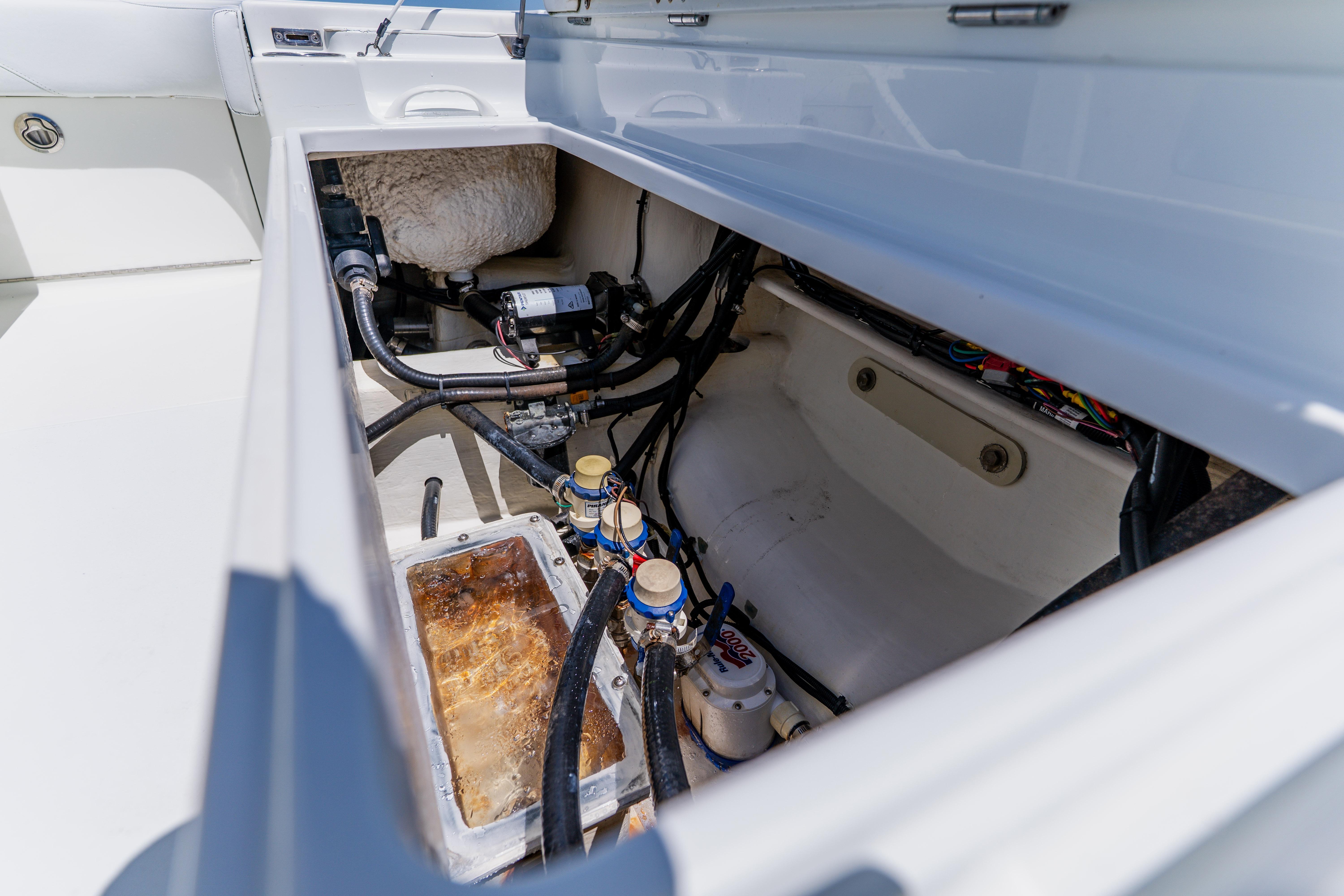 Open hatch of 2017 Barker Boatworks 26 showing internal components and wiring.