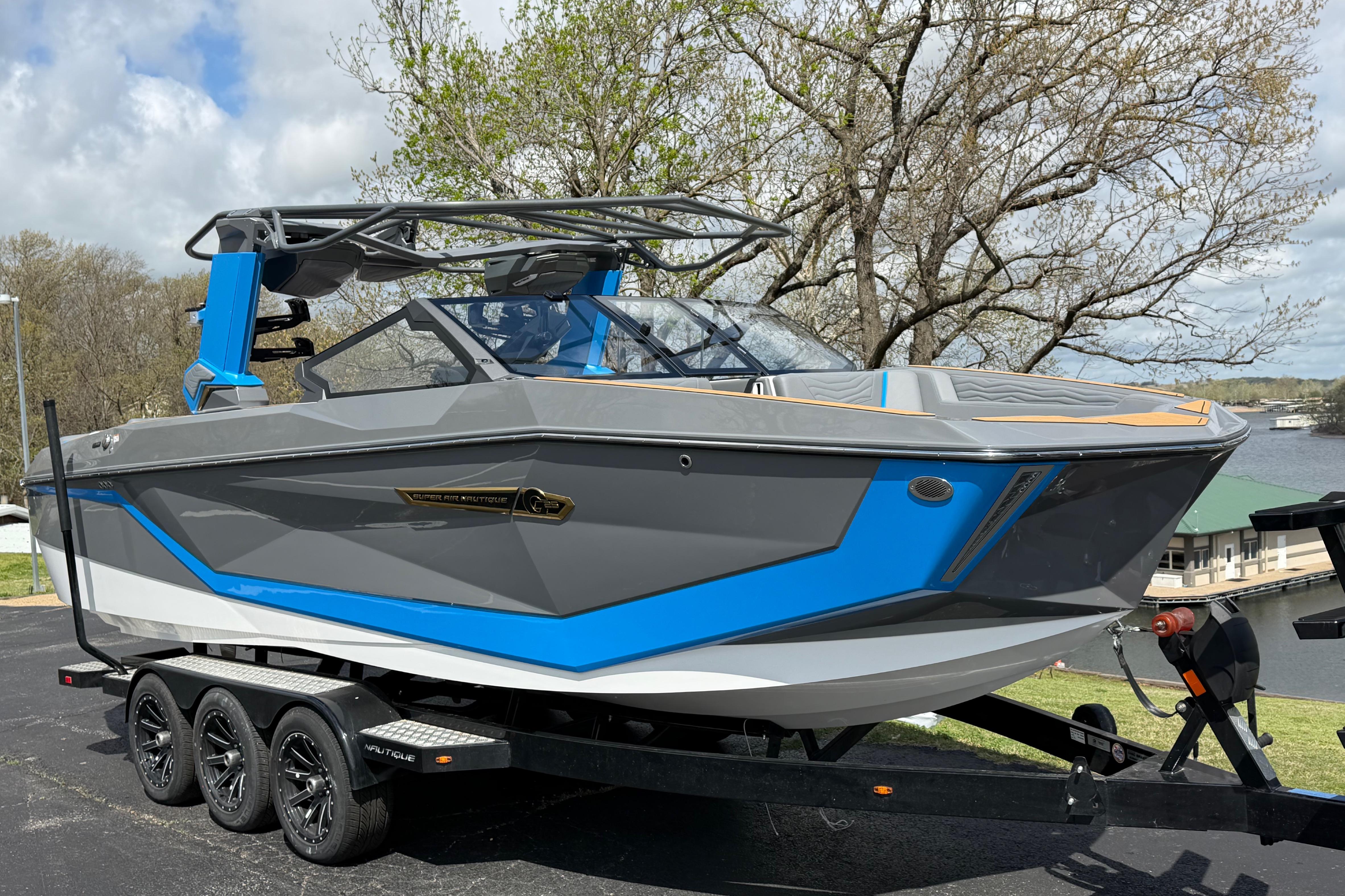 2026 Nautique Super Air Nautique G25 boat on trailer, gray and blue design.