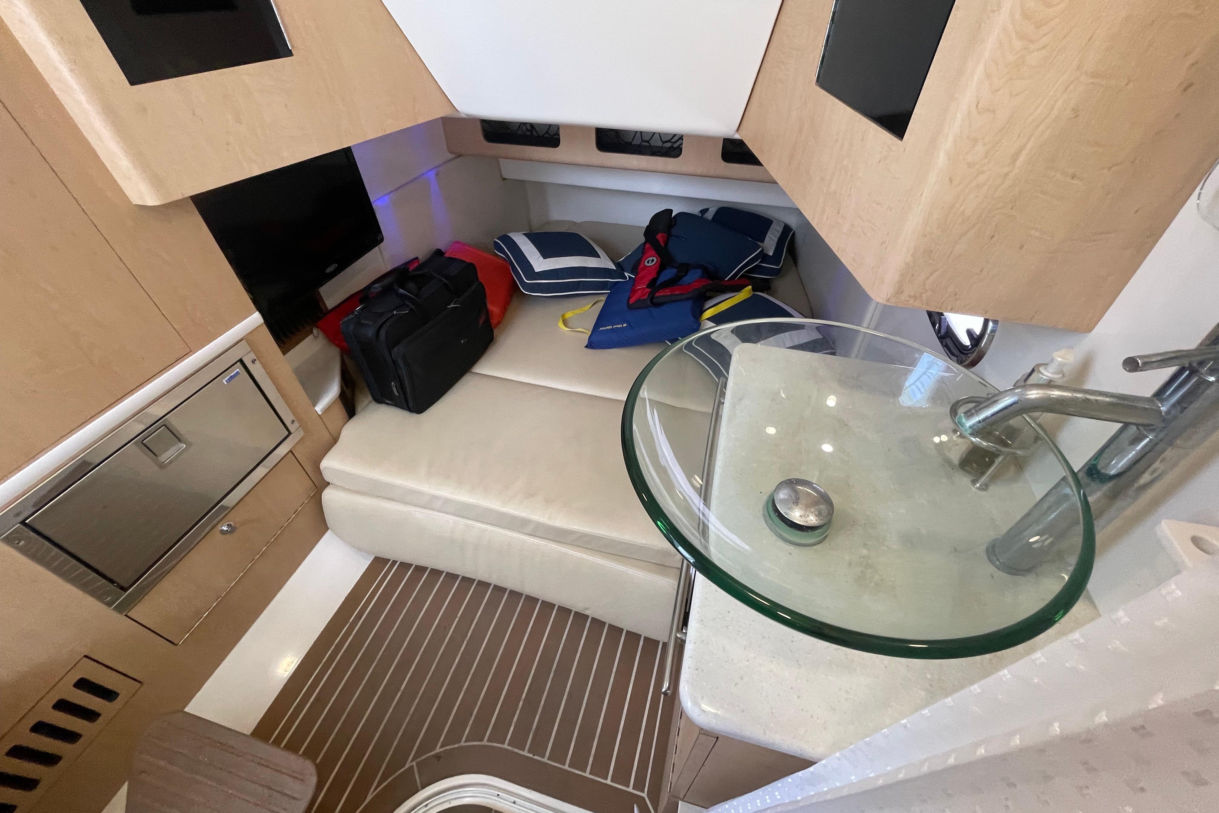Interior of 2015 Boston Whaler 370 Outrage, featuring a cozy cabin with modern amenities.