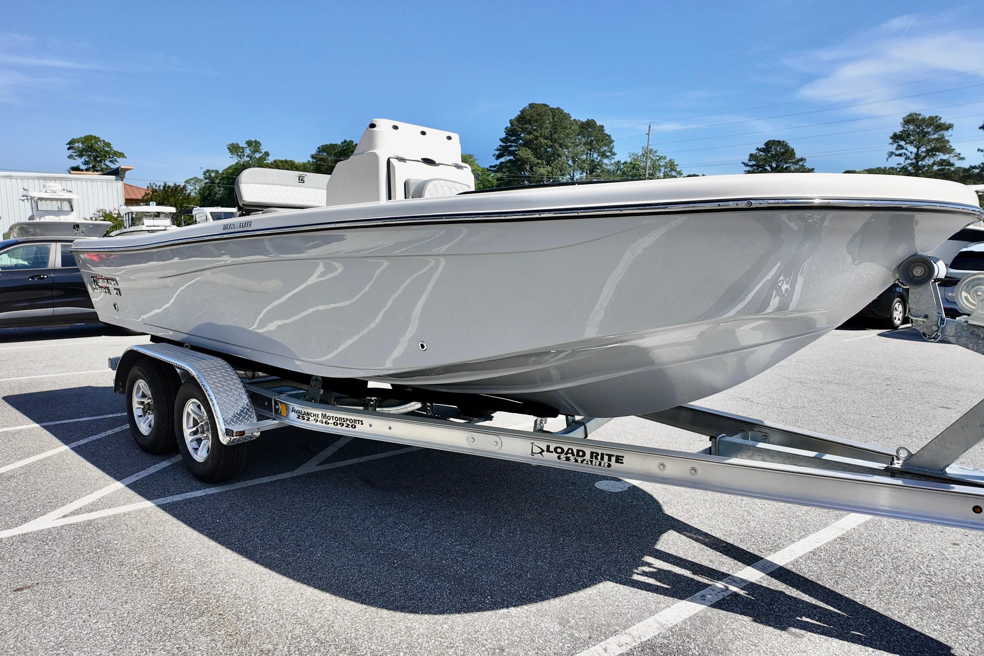 2026 Carolina Skiff 21 Ultra Elite boat on a trailer in a parking lot.