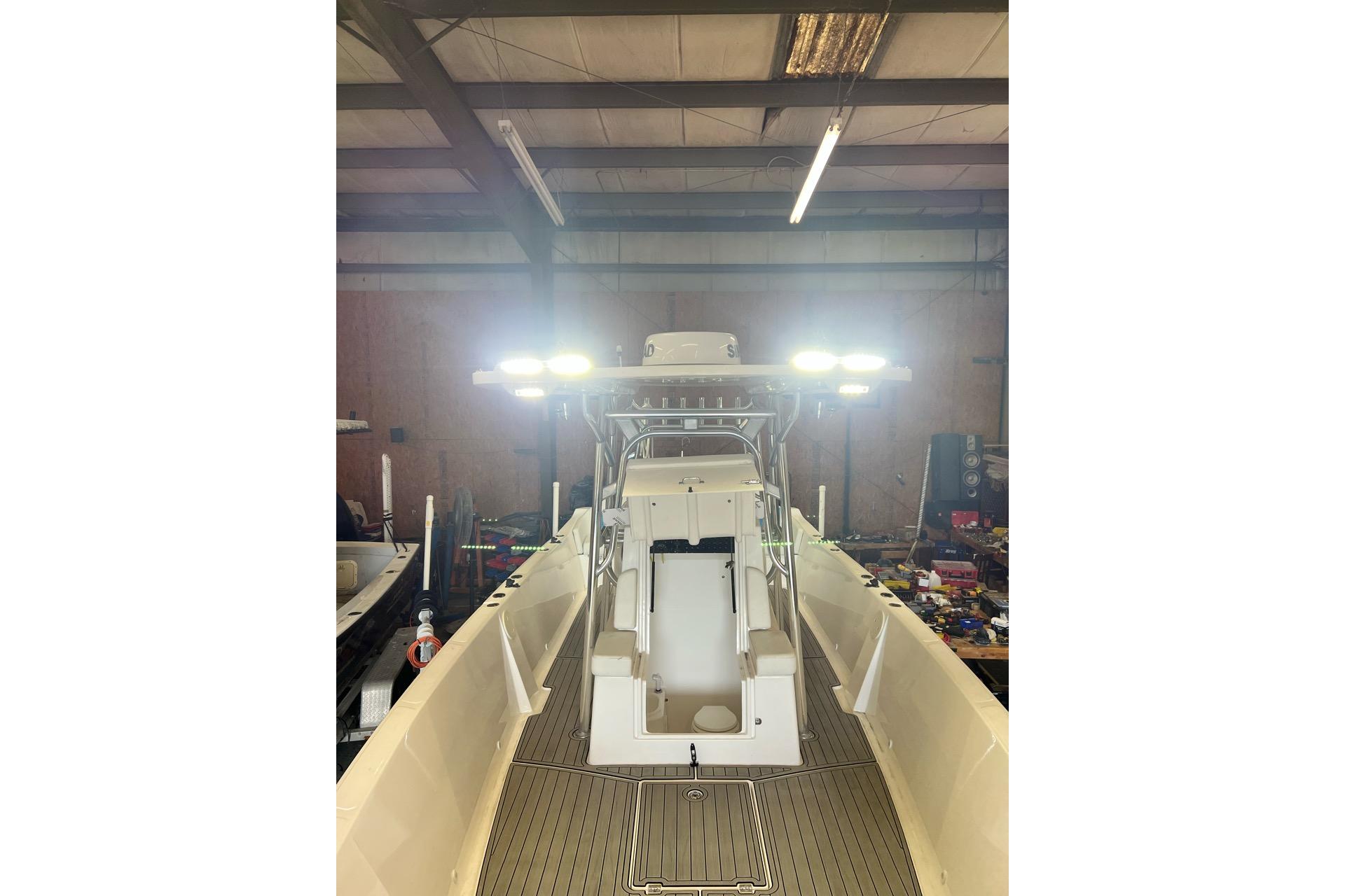 2021 Custom Infusion 34 CC boat in a workshop with bright overhead lights.