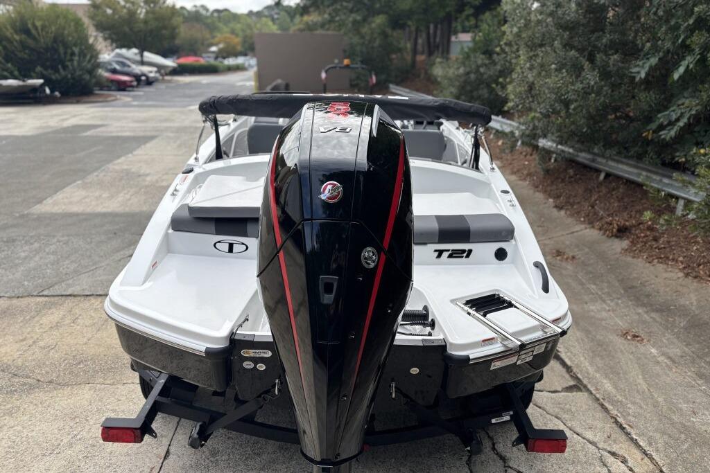 2026 Tahoe T21 boat with powerful outboard motor, parked on a concrete surface.