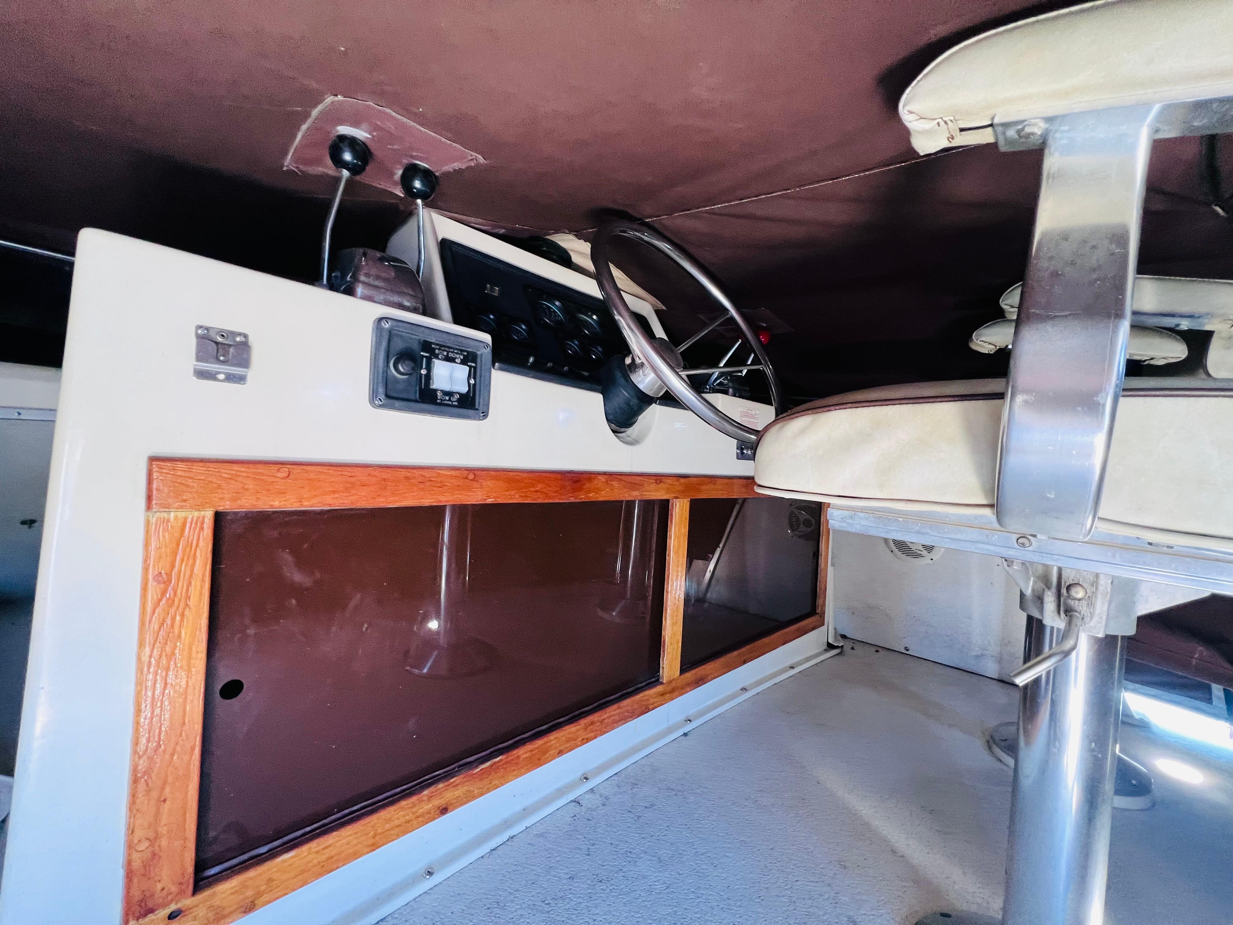 Interior of a 1982 Trojan F32 boat cockpit with steering wheel and controls.