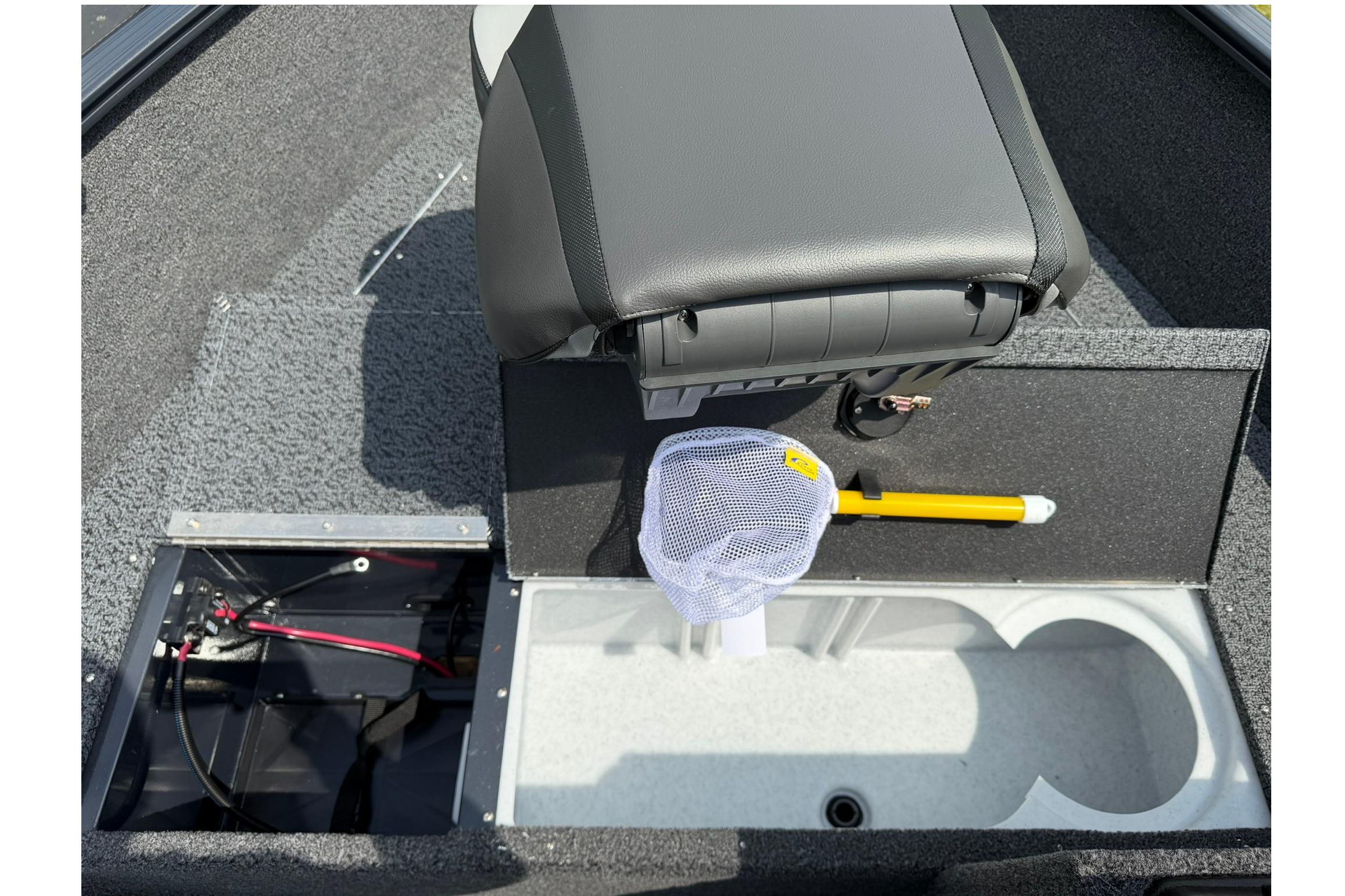 Interior of 2027 Lund 1650 Rebel XL SS boat with storage compartments and seat.