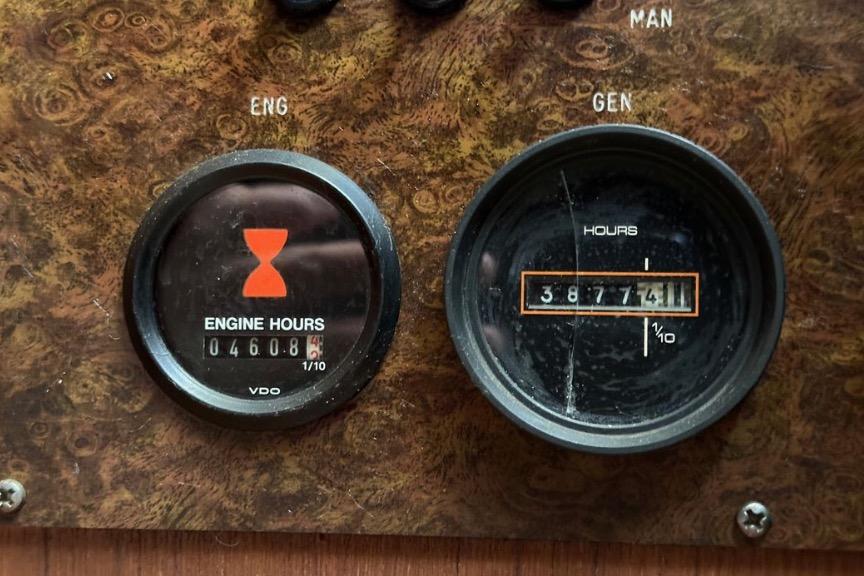 Close-up of Egg Harbor 33 Sedan 1985 engine and generator hour meters.