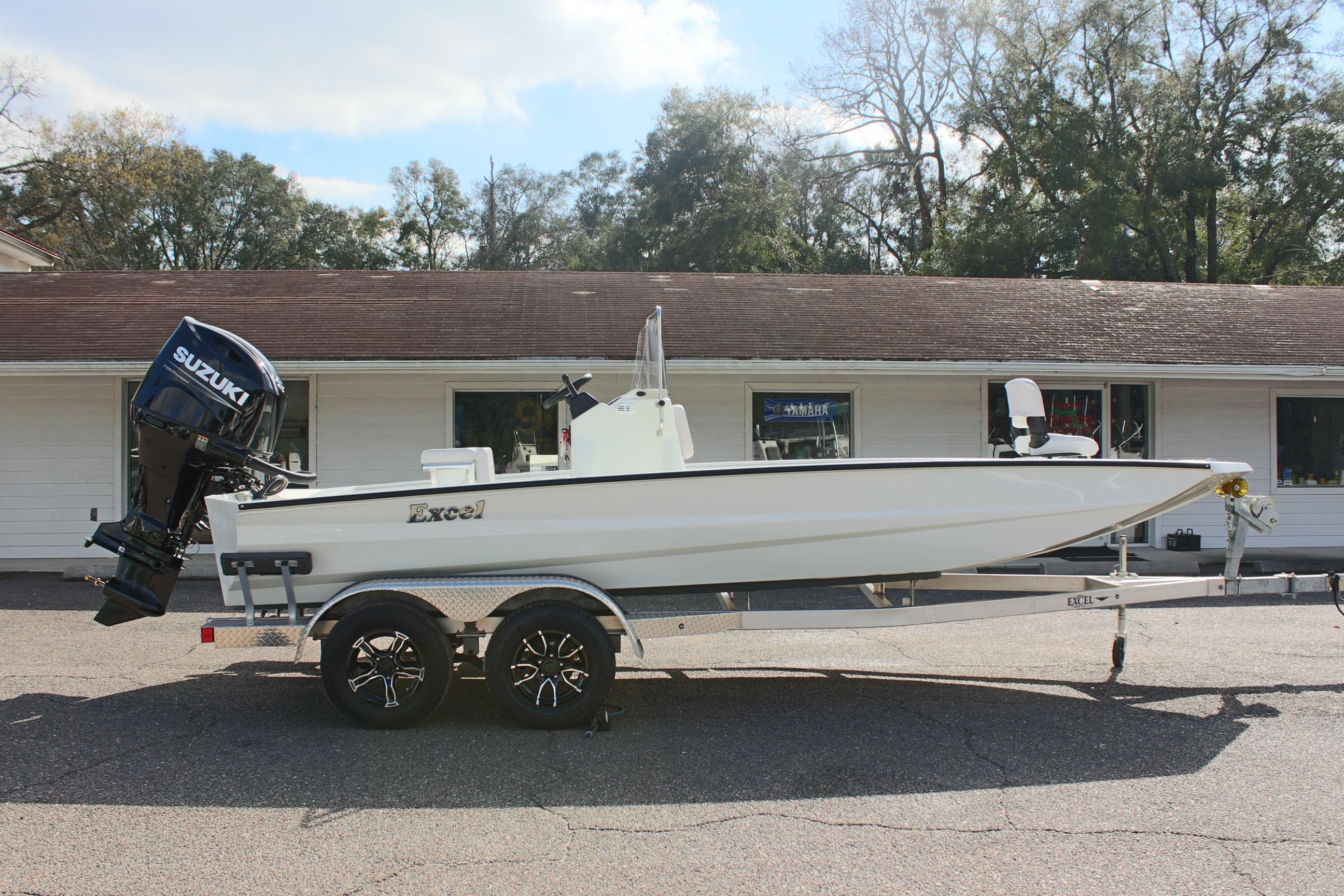 2025 Excel 2172 Stalker CC boat with Suzuki outboard motor on trailer, parked outdoors.