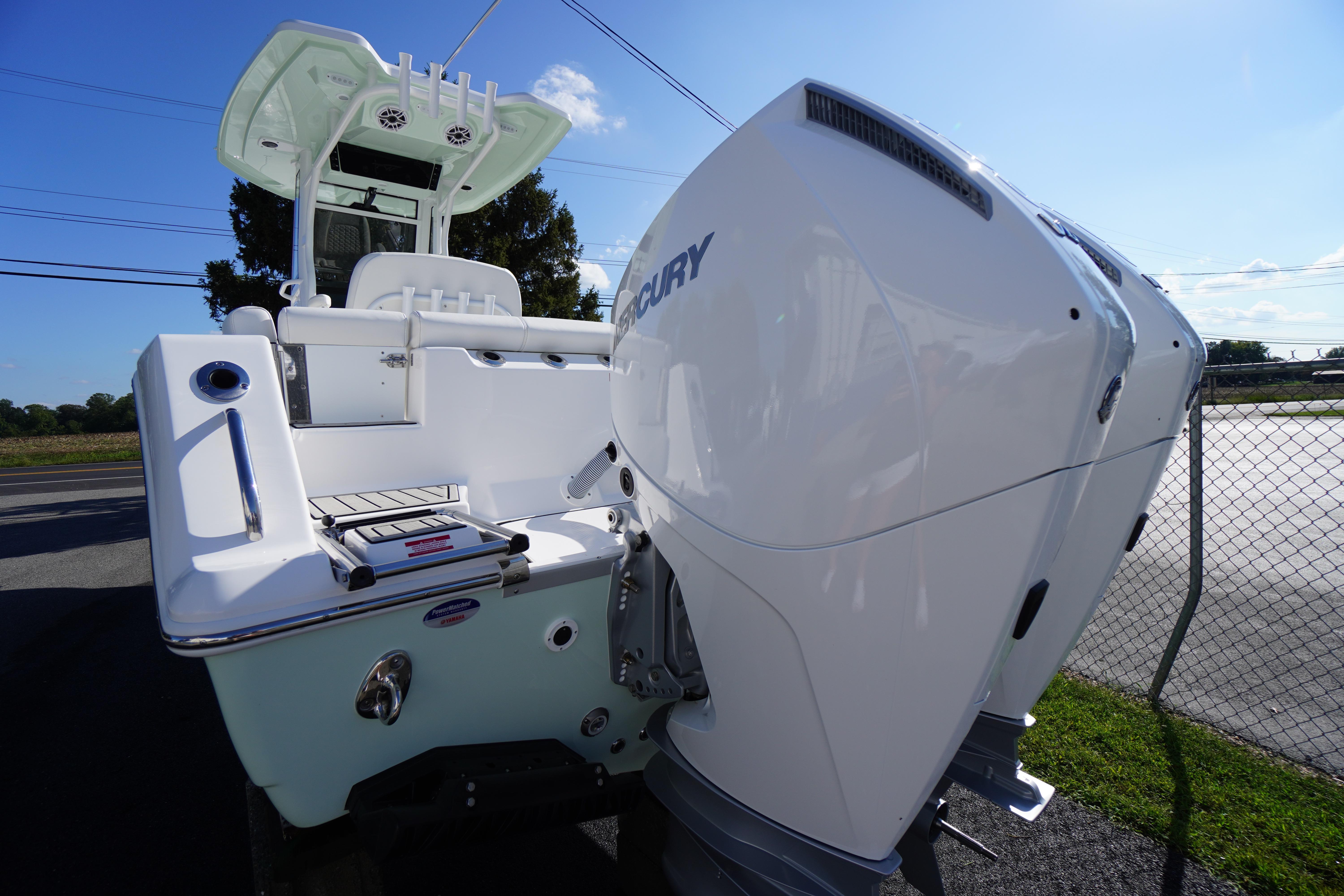 2026 Tidewater 272 LXF boat with dual Mercury engines, docked outdoors.