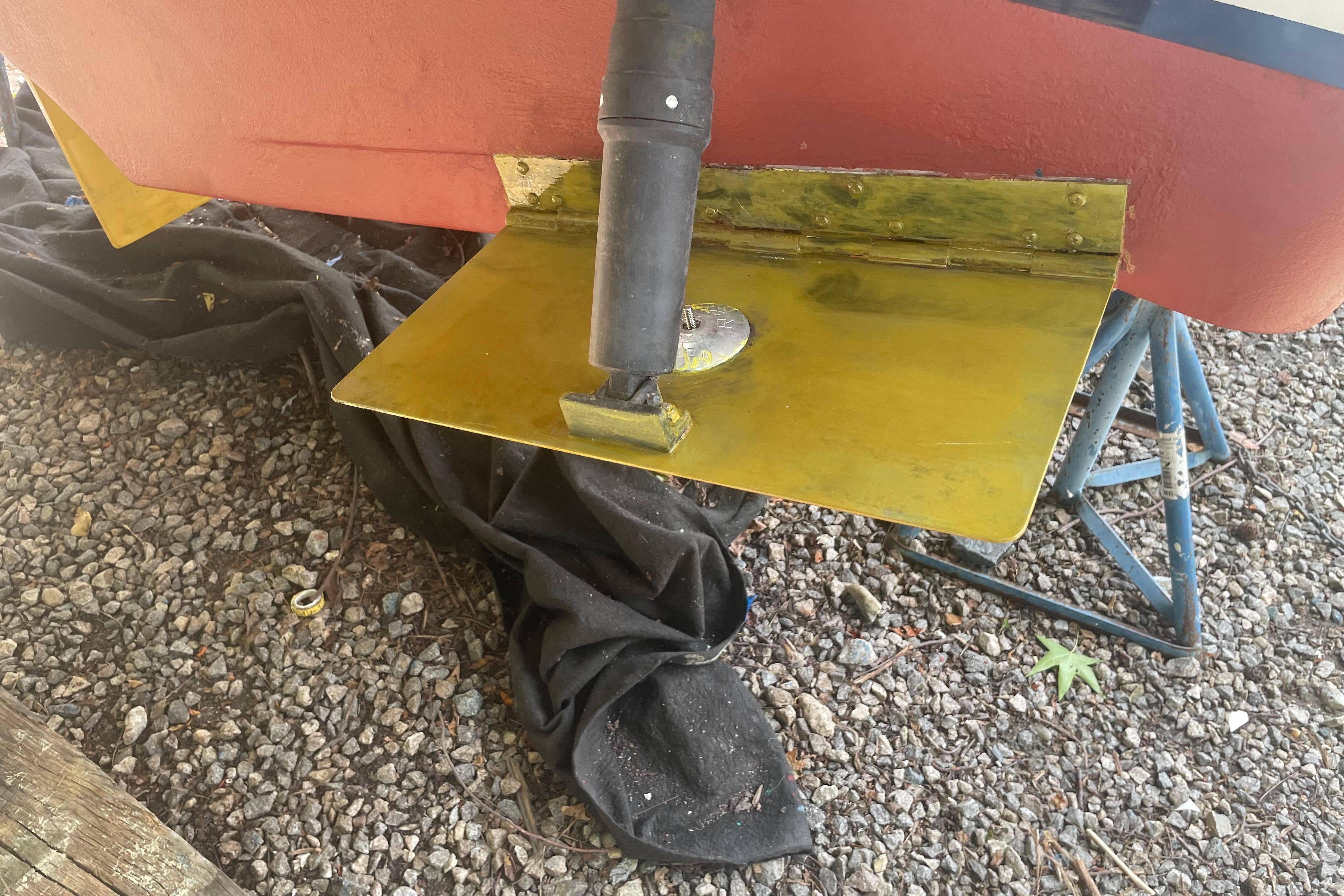 2007 Back Cove 29 boat propeller and rudder on gravel surface.