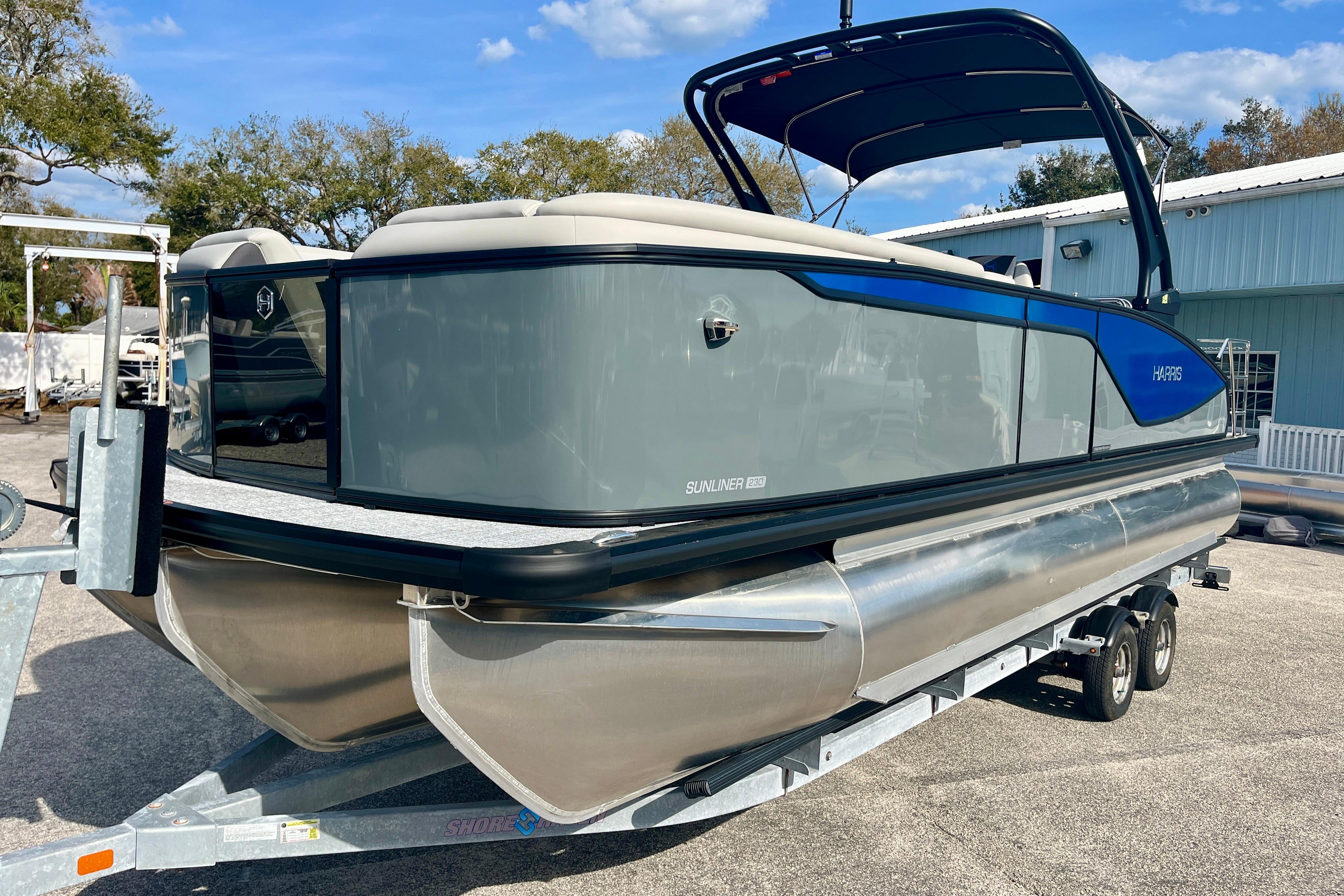 2026 Harris Sunliner 230 Sport pontoon boat on trailer.