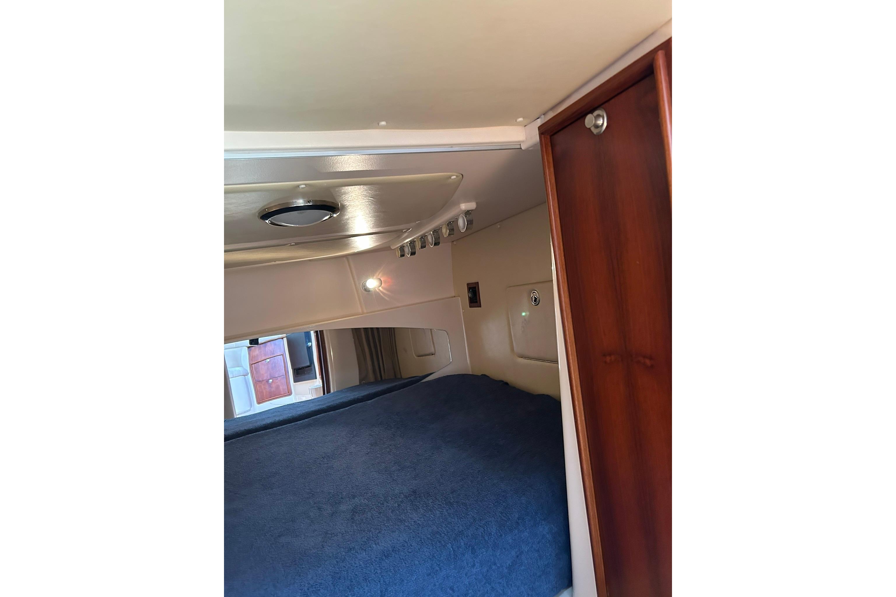 2007 Grady-White Express 360 cabin interior with bed and wooden cabinetry.