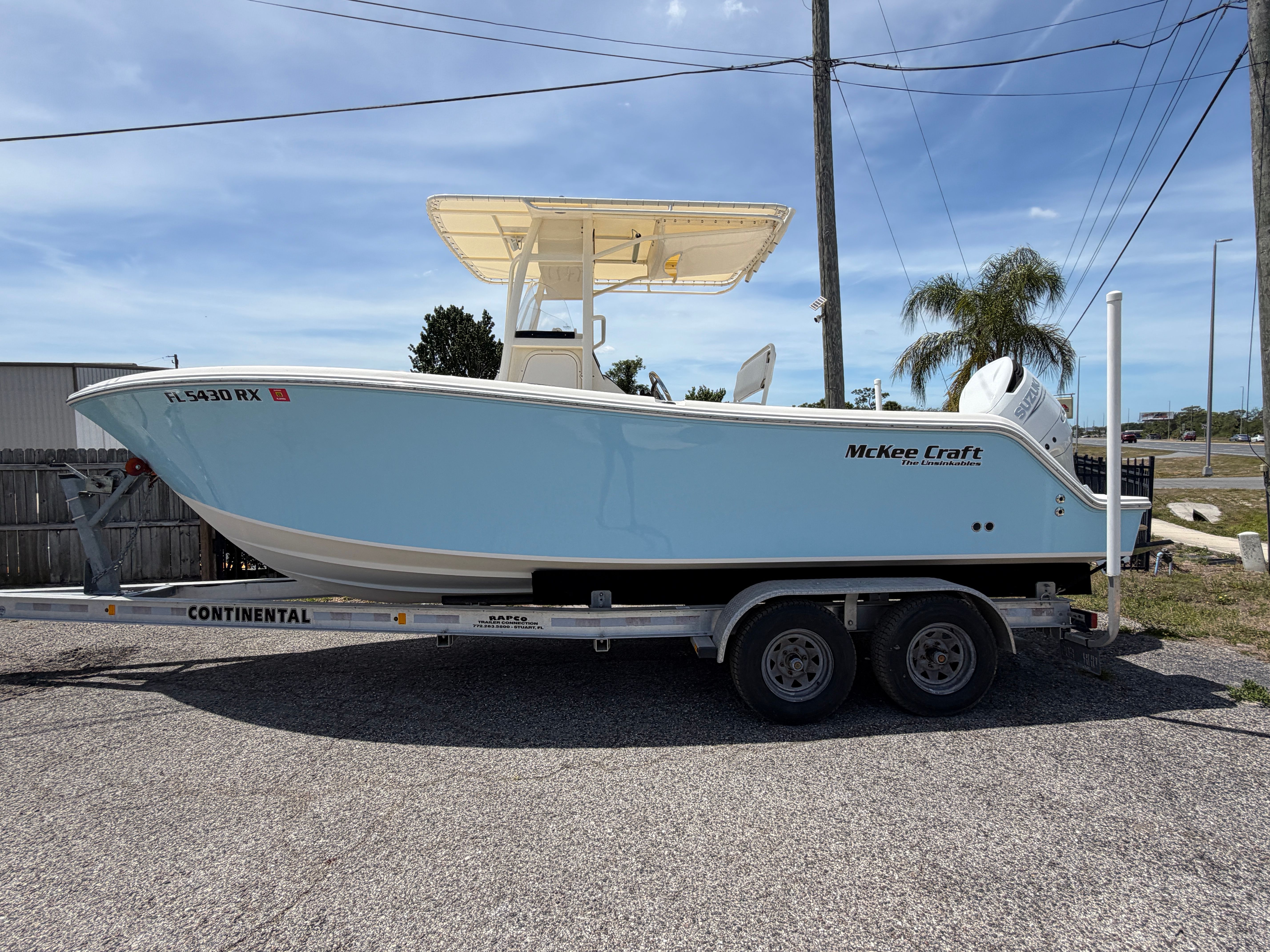 2004 McKee Craft 24 FREEDOM boat on trailer, side view.