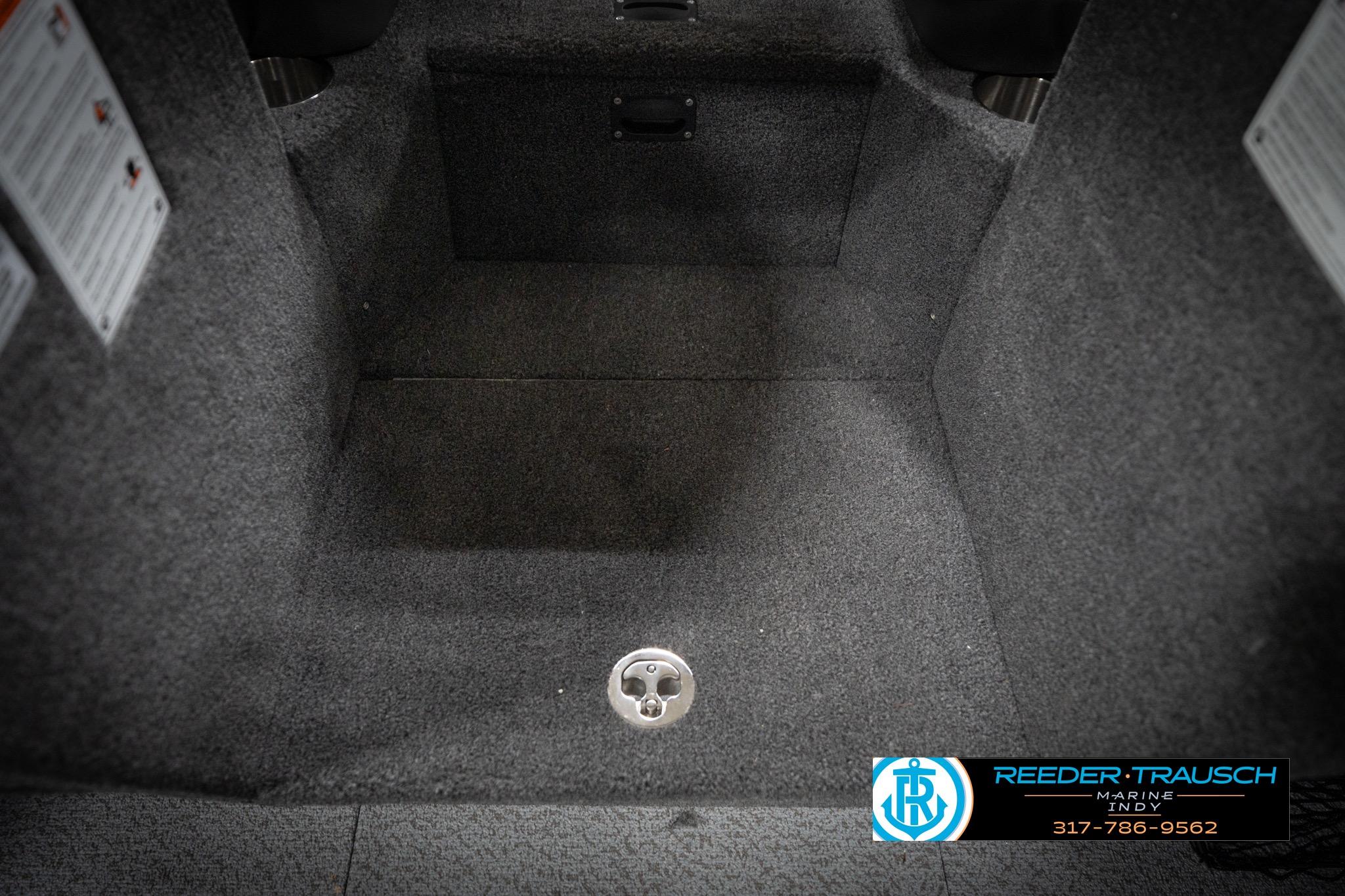 2026 Lund 2275 Baron boat interior with carpeted flooring and drain plug.