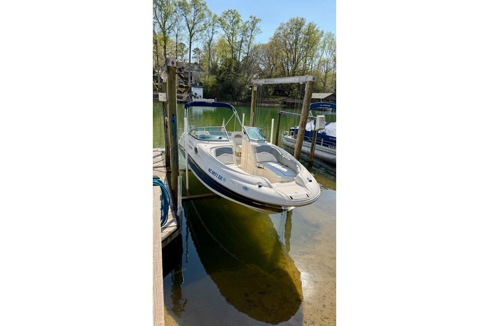 2008 Sea Ray 240 Sundeck boat docked on a calm lake.
