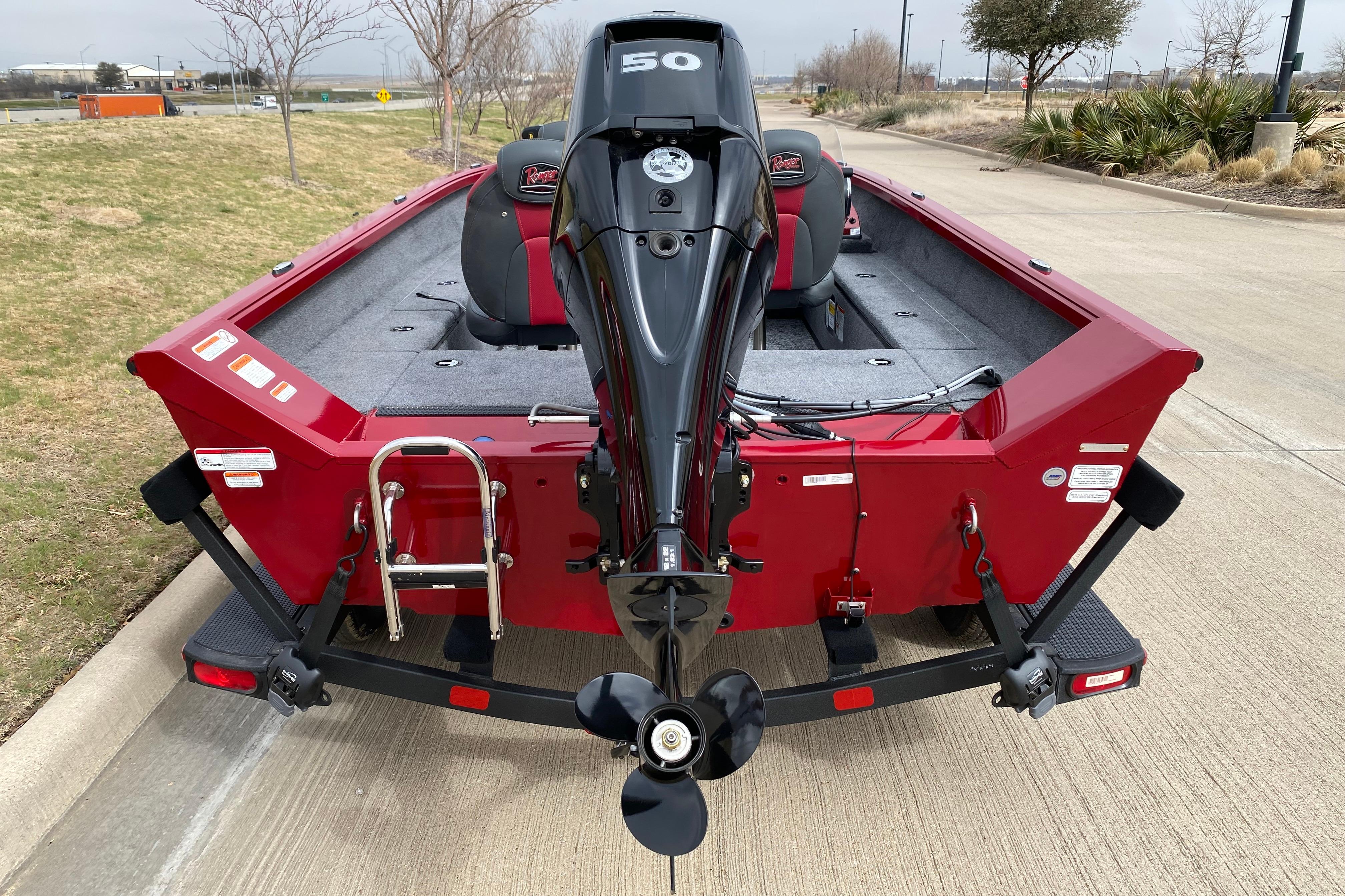 2026 Ranger VS1665SC boat with powerful outboard motor, parked on a concrete path.