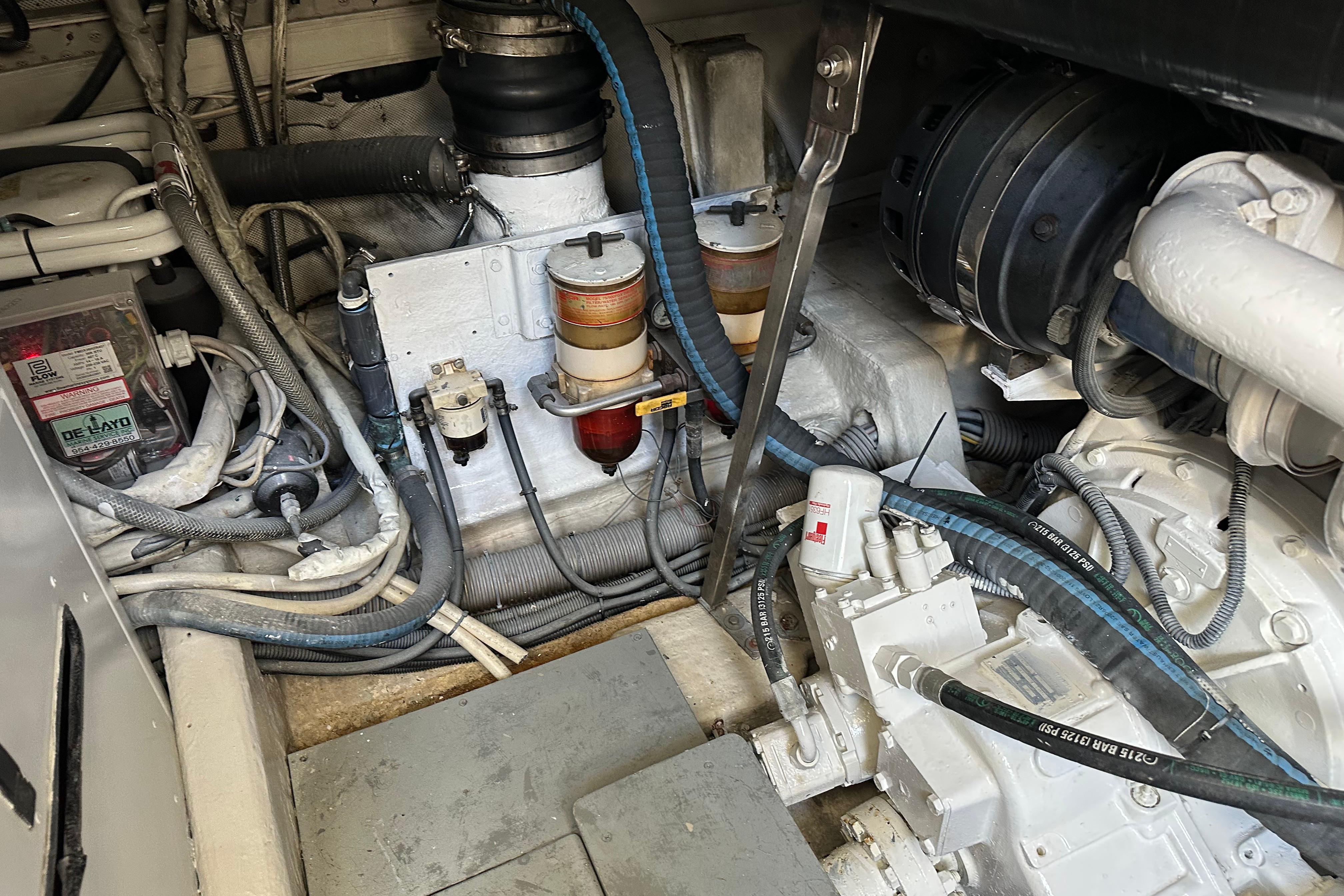 Engine room of a 2004 Azimut 55E yacht, showcasing mechanical components and wiring.