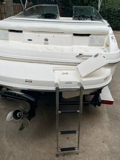The image shows the rear of a white Chaparral 190 SSi boat with a swim ladder.