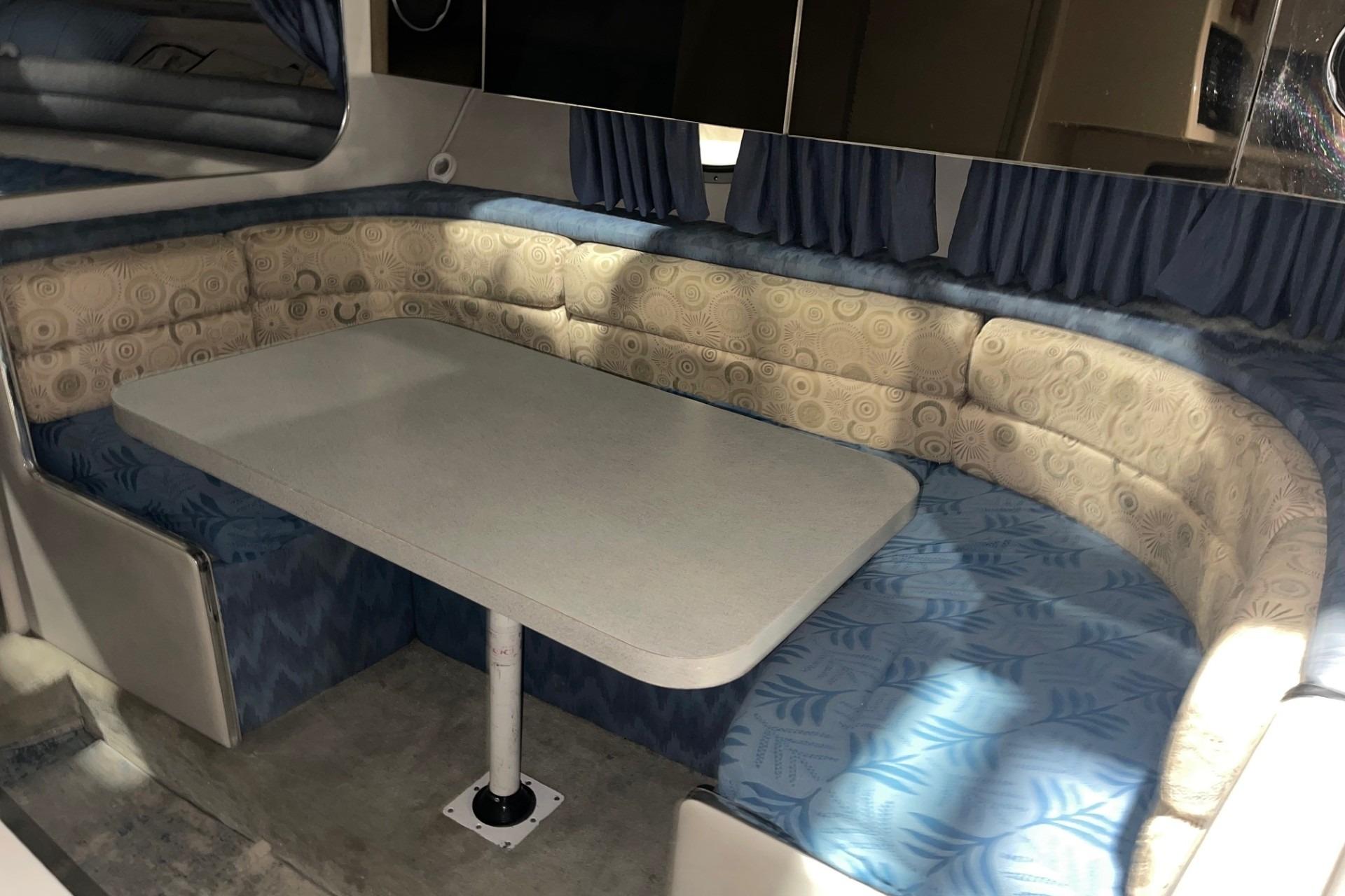 Interior of 1992 Chaparral Signature 30 boat with cushioned seating and table.