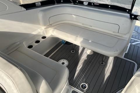 2012 Bayliner 285 Cruiser interior seating with gray flooring and cup holders.