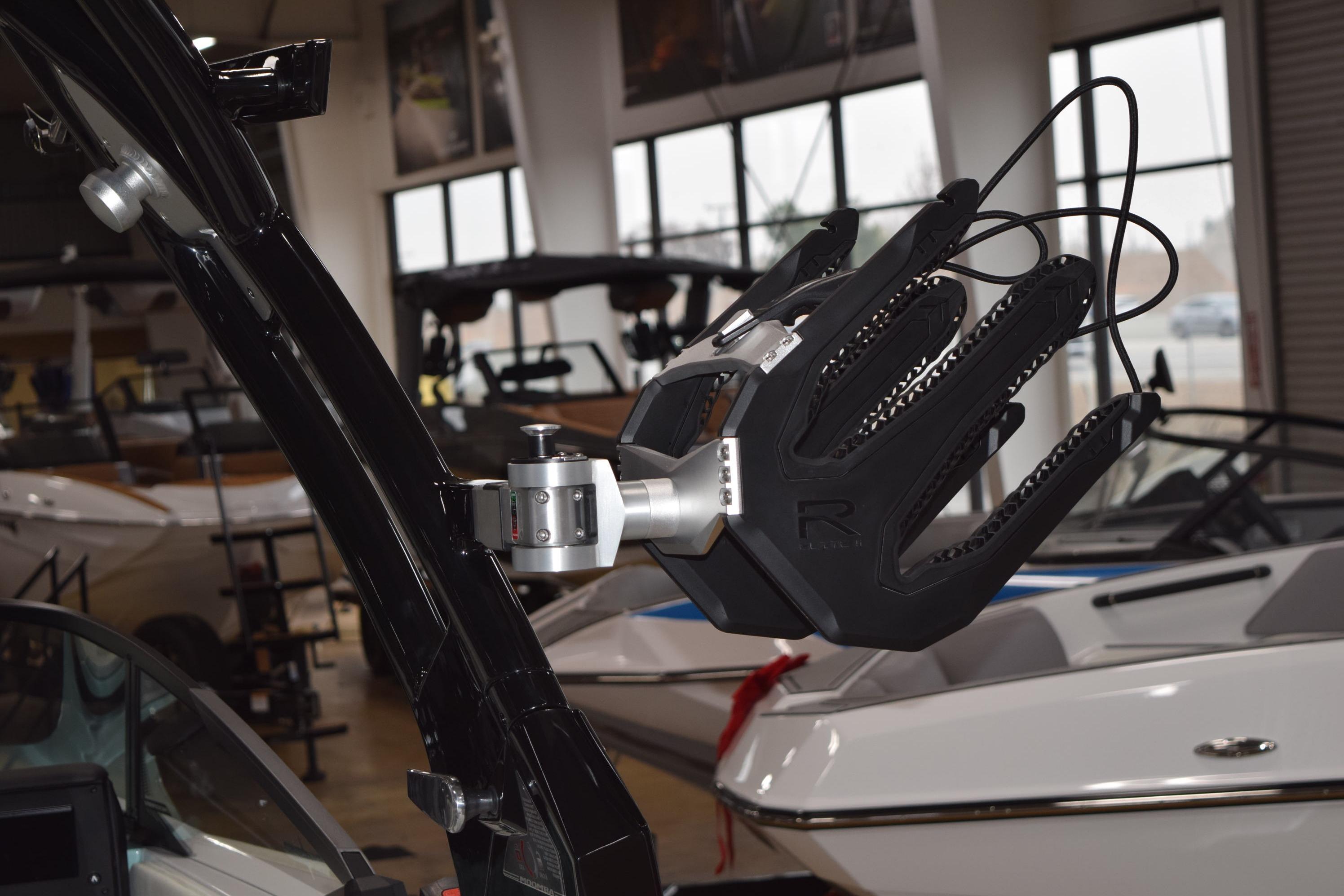 2025 Moomba Mojo boat with advanced wakeboard rack in showroom.