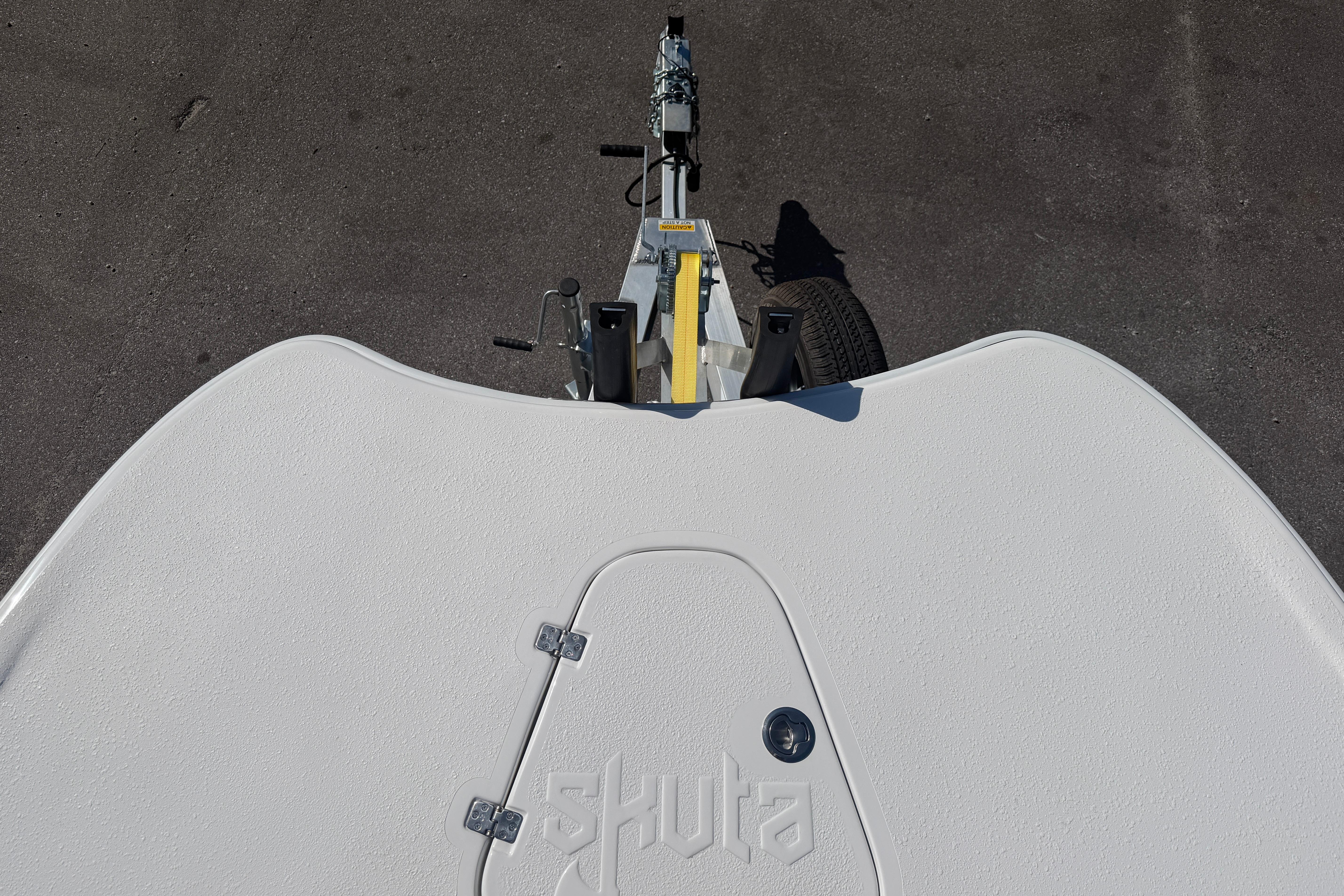 Top view of a 2026 Skuta 24 Cat boat on a trailer.