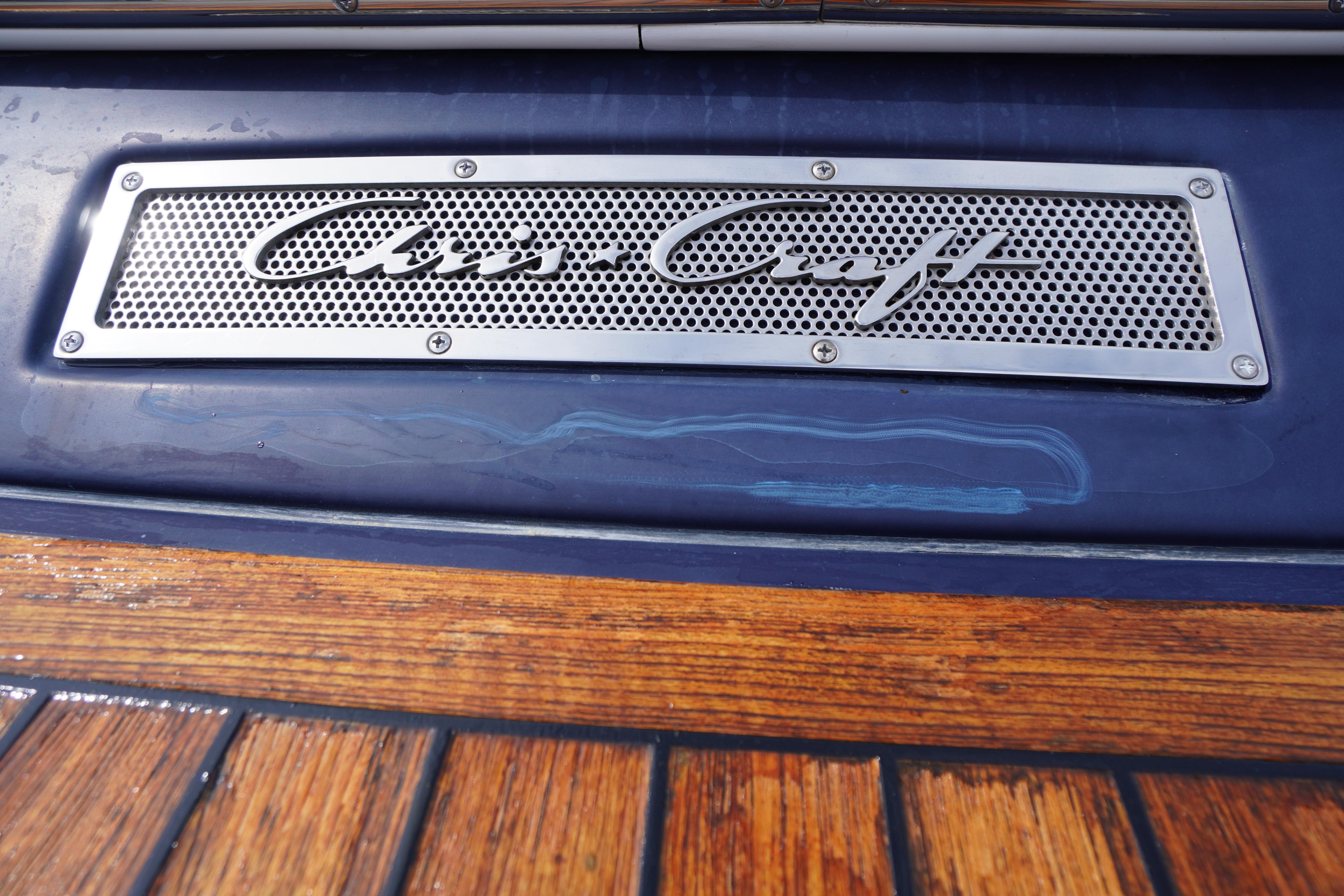 2005 Chris Craft Speedster Heritage logo on blue and wood boat surface.