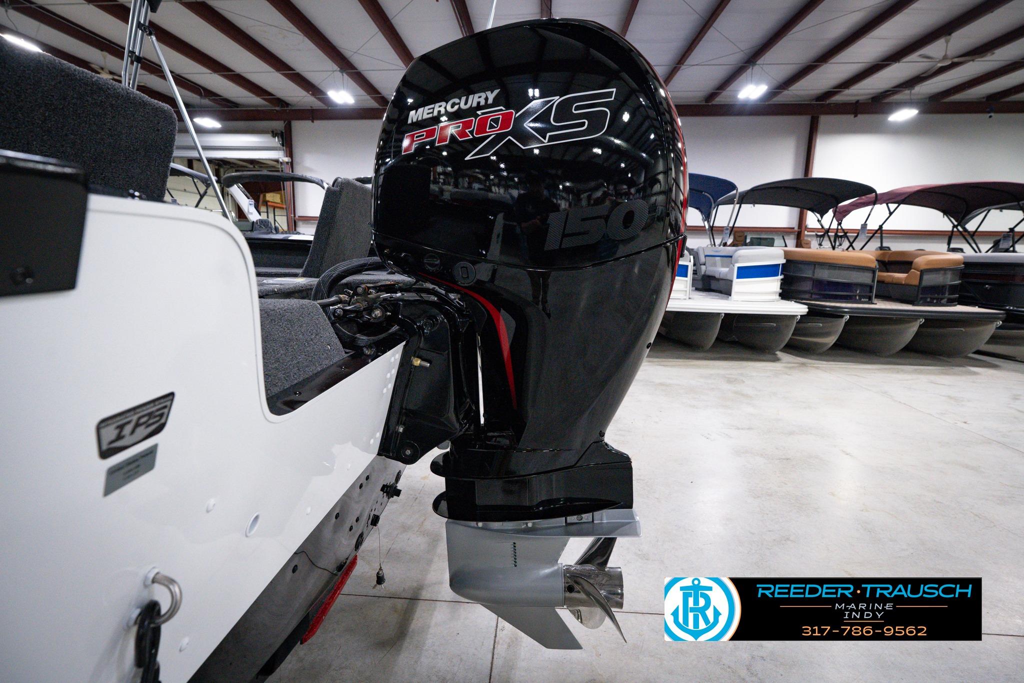 2026 Lund 1875 Impact XS SS boat with Mercury Pro XS 150 engine in showroom.