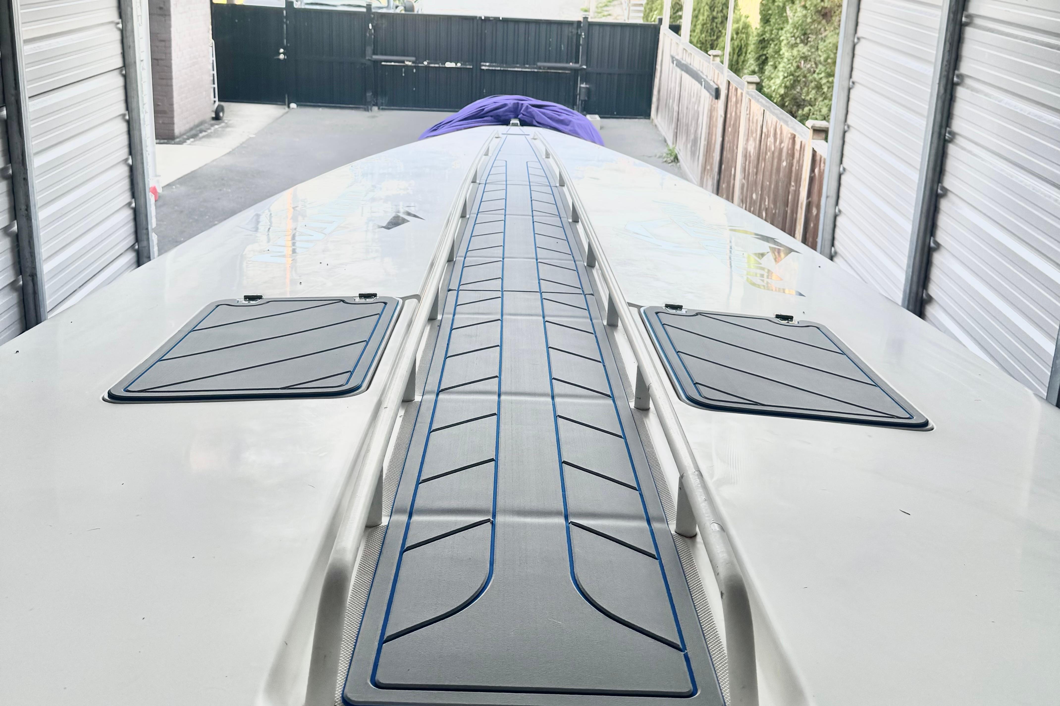 1999 Fountain 38 SC boat deck in storage, featuring sleek design and hatches.