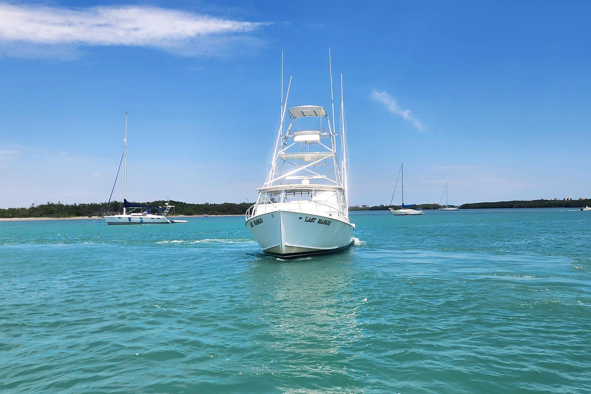 1987 Young Brothers Custom Sport Fish boat cruising on clear blue water.