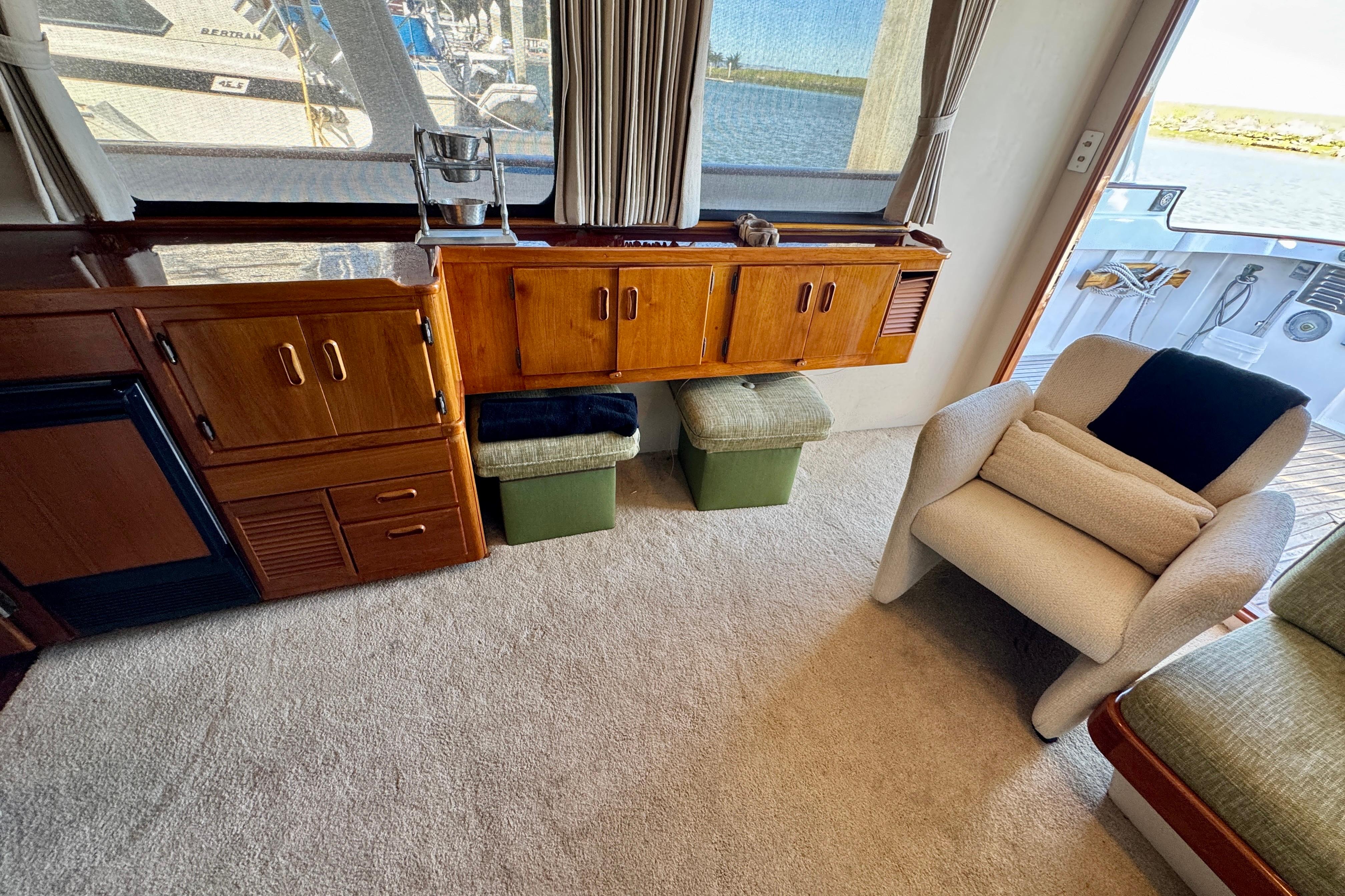 Interior of a 1958 Blanchard Pilothouse with wooden cabinetry and comfortable seating.