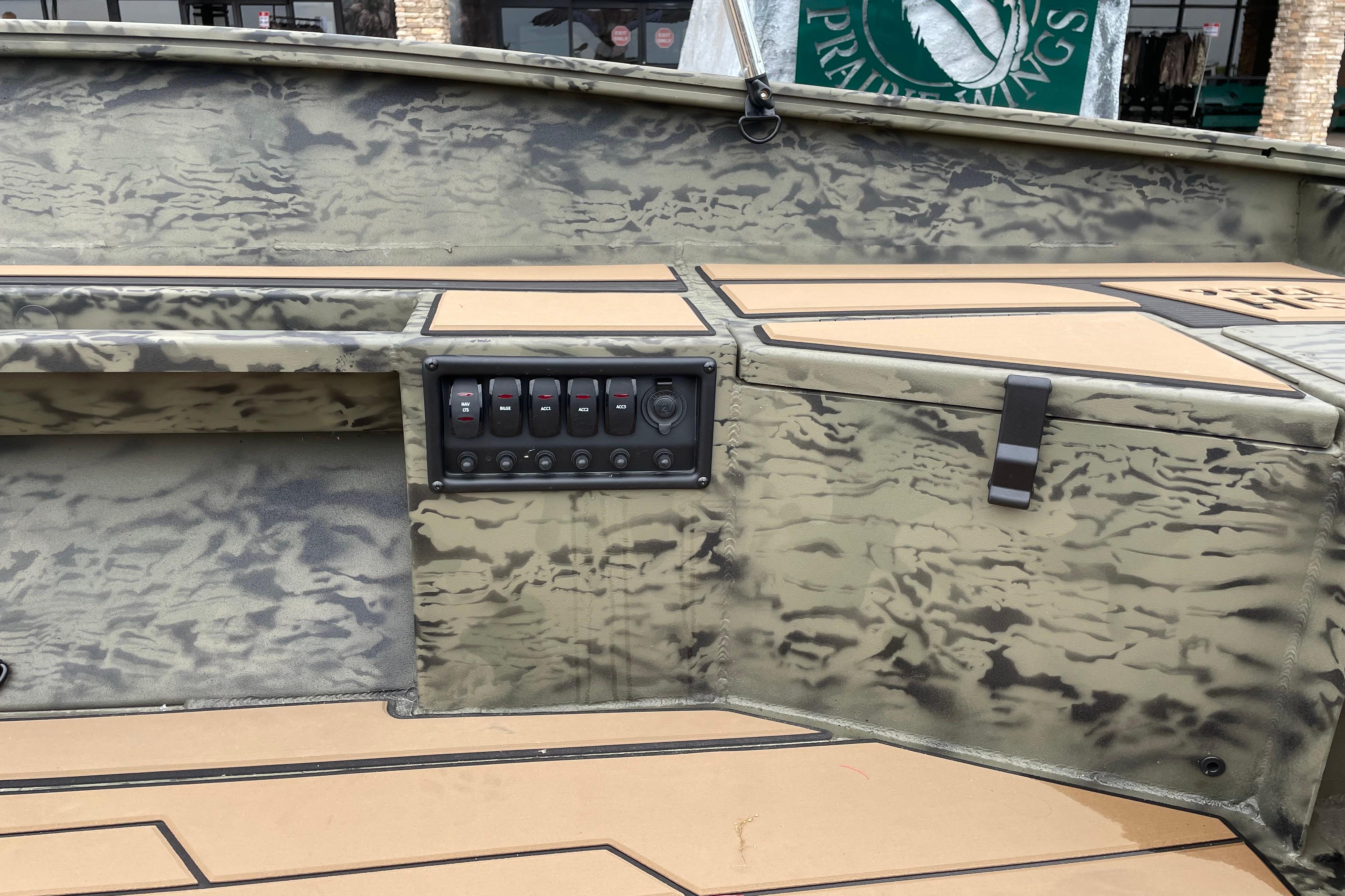 2026 Tracker Grizzly 1756 T Marsh boat interior with camouflage design and control panel.