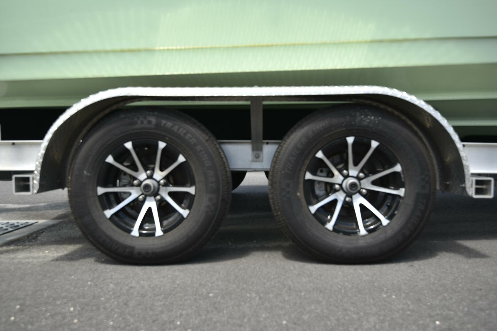 2023 Sea Pro 239 Deep V CC trailer wheels on pavement, showcasing dual black tires.